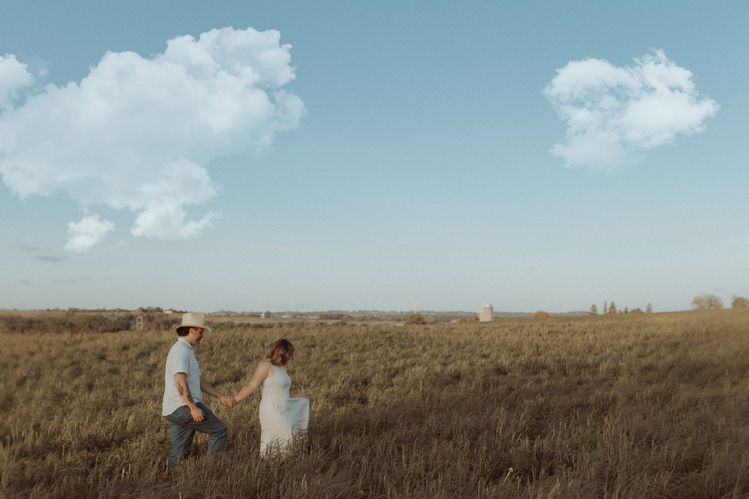 Engagement couple walking in field at sunset in Orono Ontario photographed by family photographer