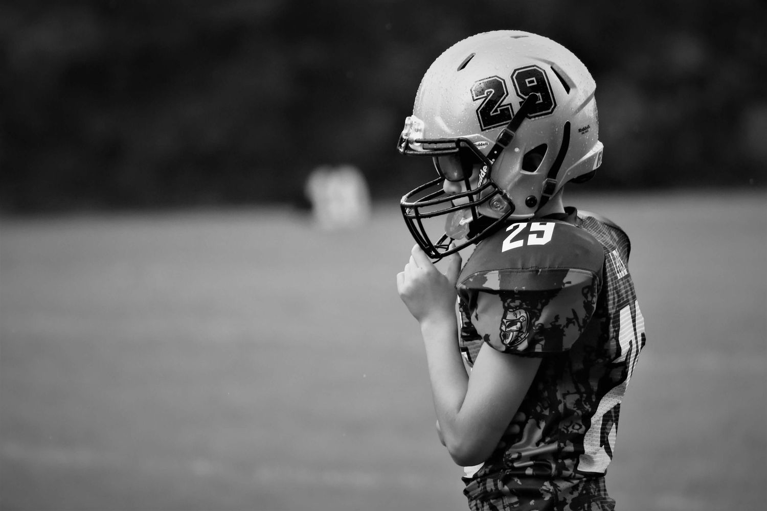 Football players on the field during a game wearing protective gear and uniforms.