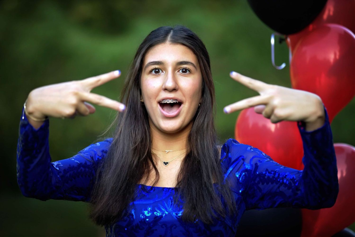 Series of expressive poses in a blue sequined outfit against a natural background.