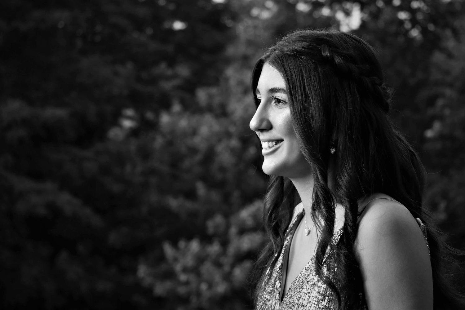 Portrait series in black and white showing joyful expressions outdoors.