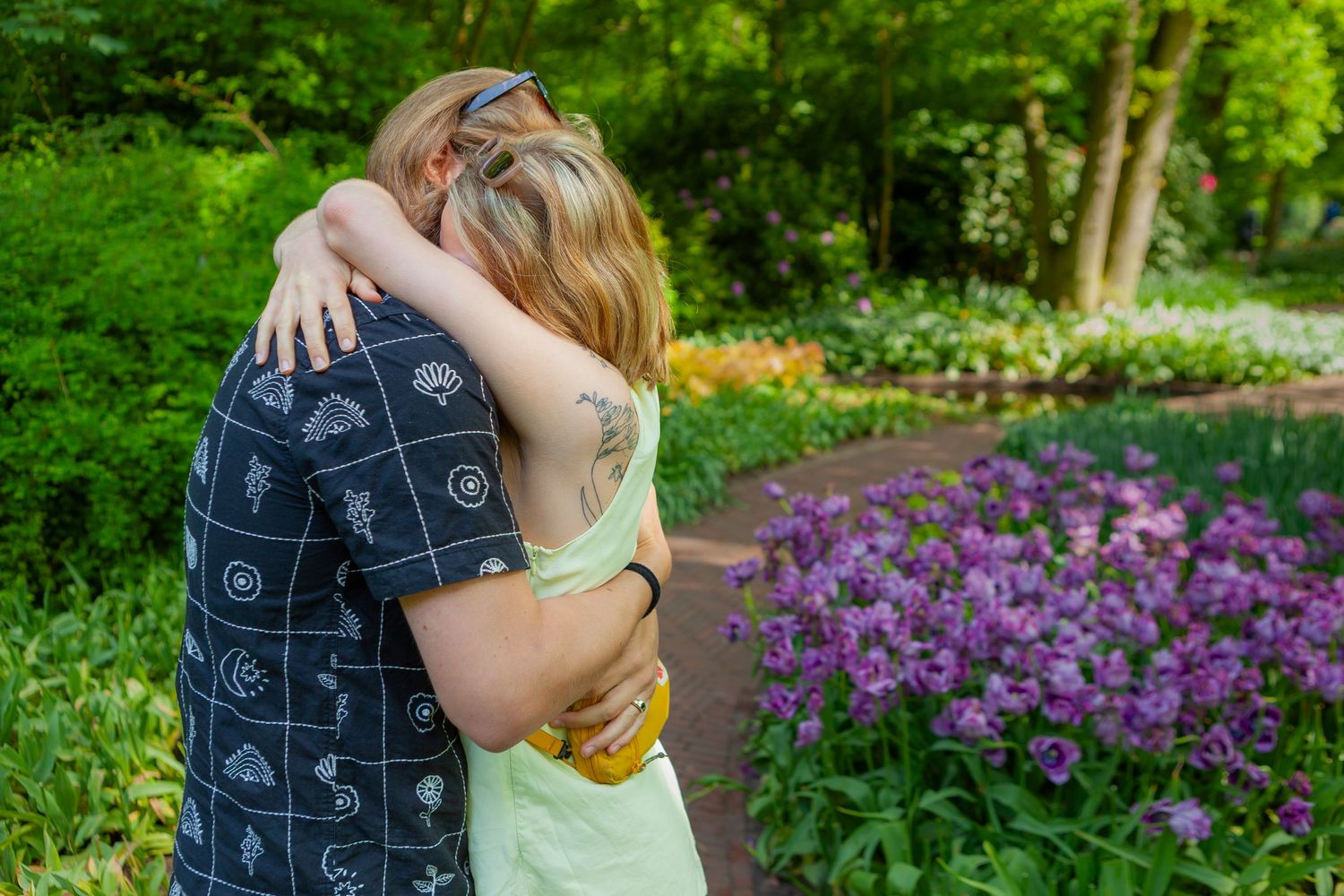 A hugging couple after a proposal, photographed digitally in the Keukenhof, a flower garden.