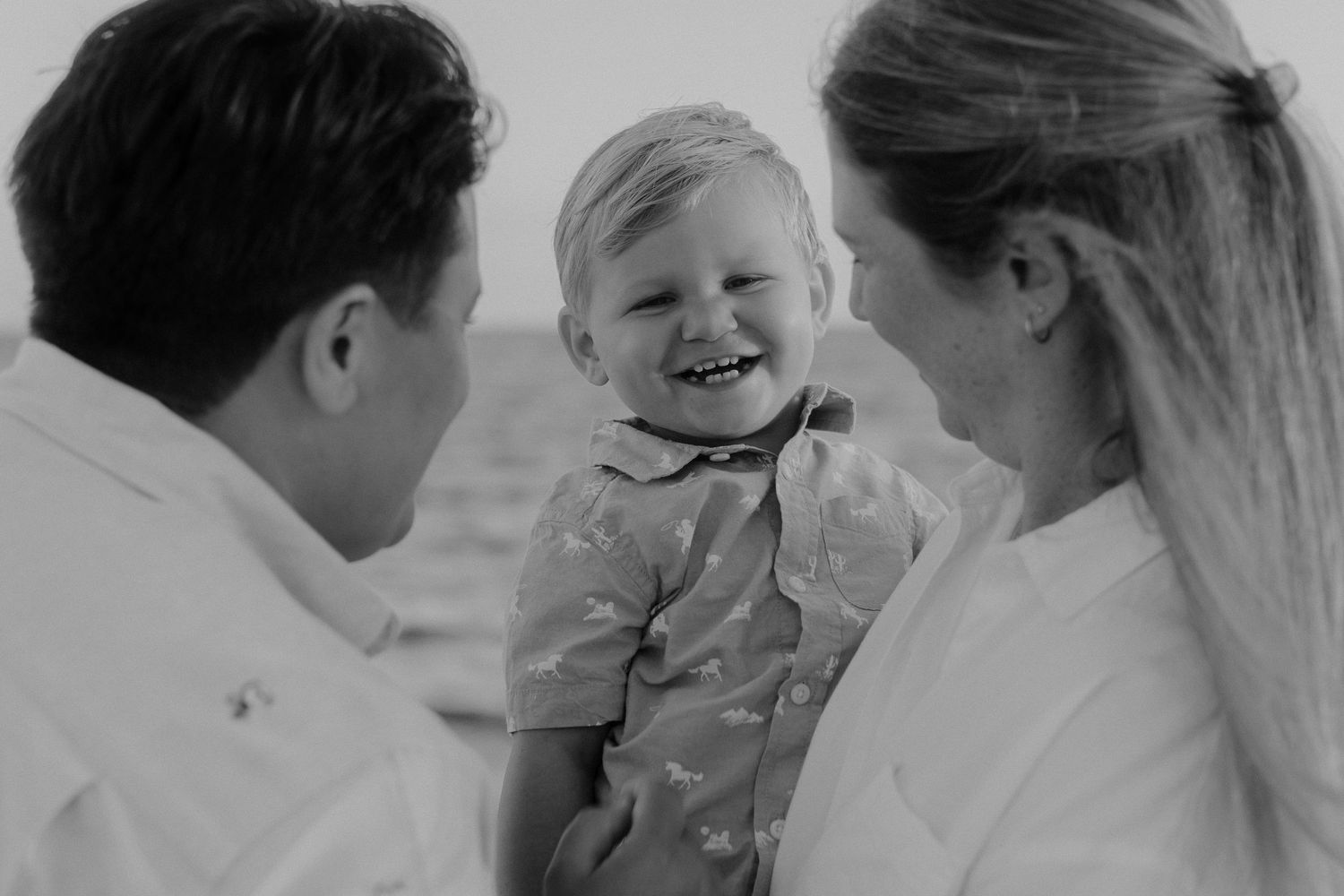 Candid black and white photos of a family haring joyful moments together.