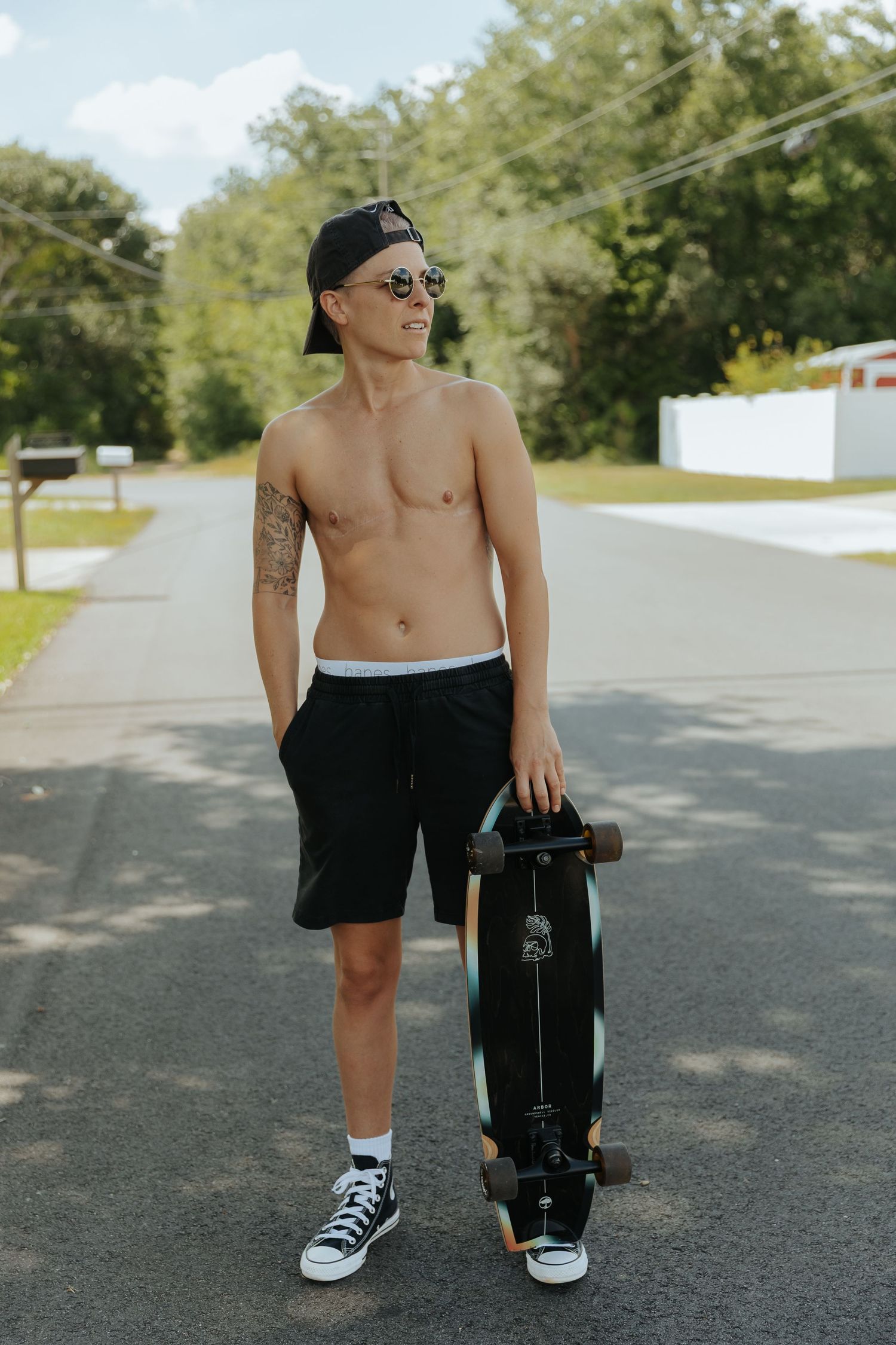 A series of photos showing someone wearing black shorts and sneakers standing on an asphalt road with trees in background.