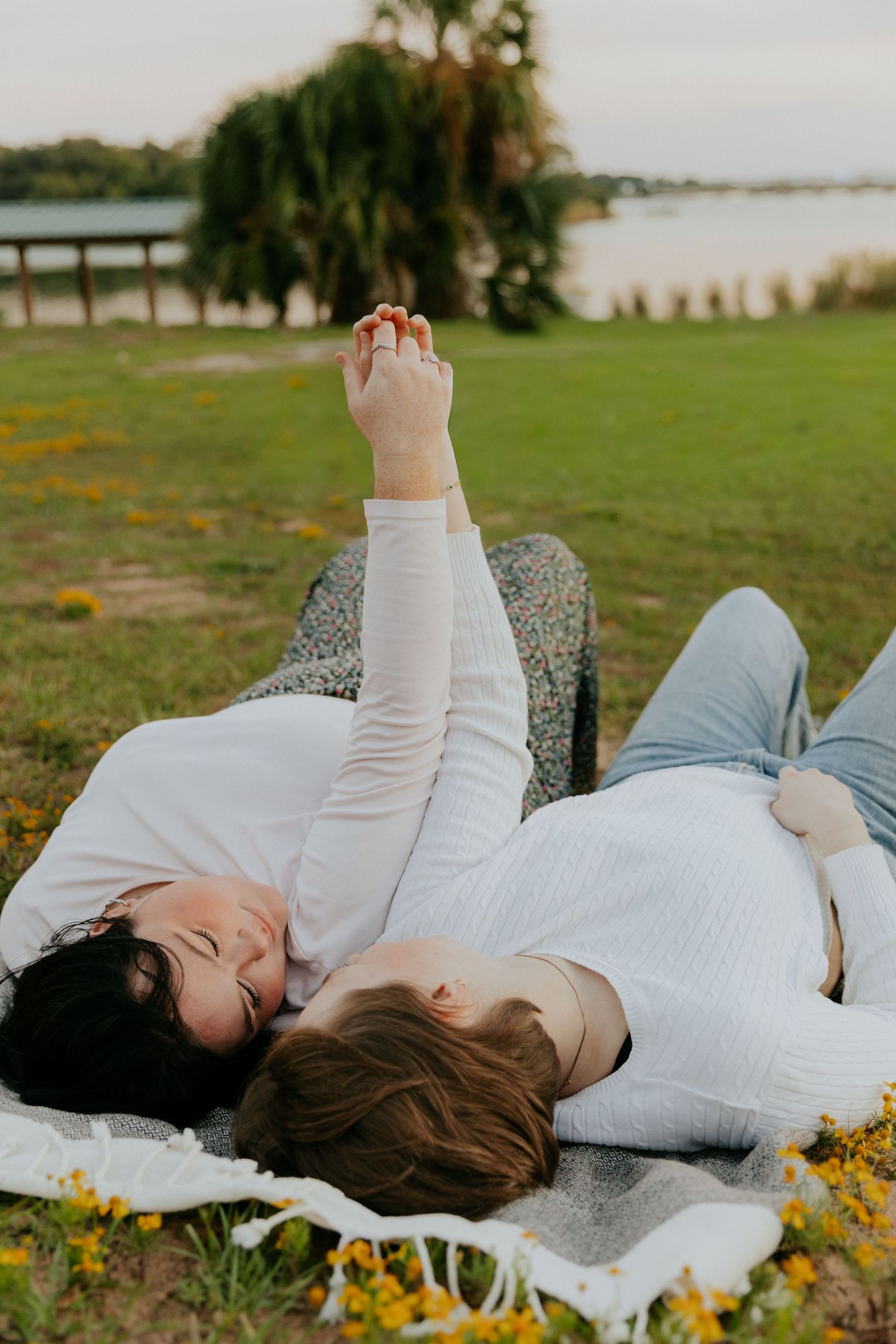 A series of photos showing someone lying in a field of yellow wildflowers wearing a white dress at sunset.