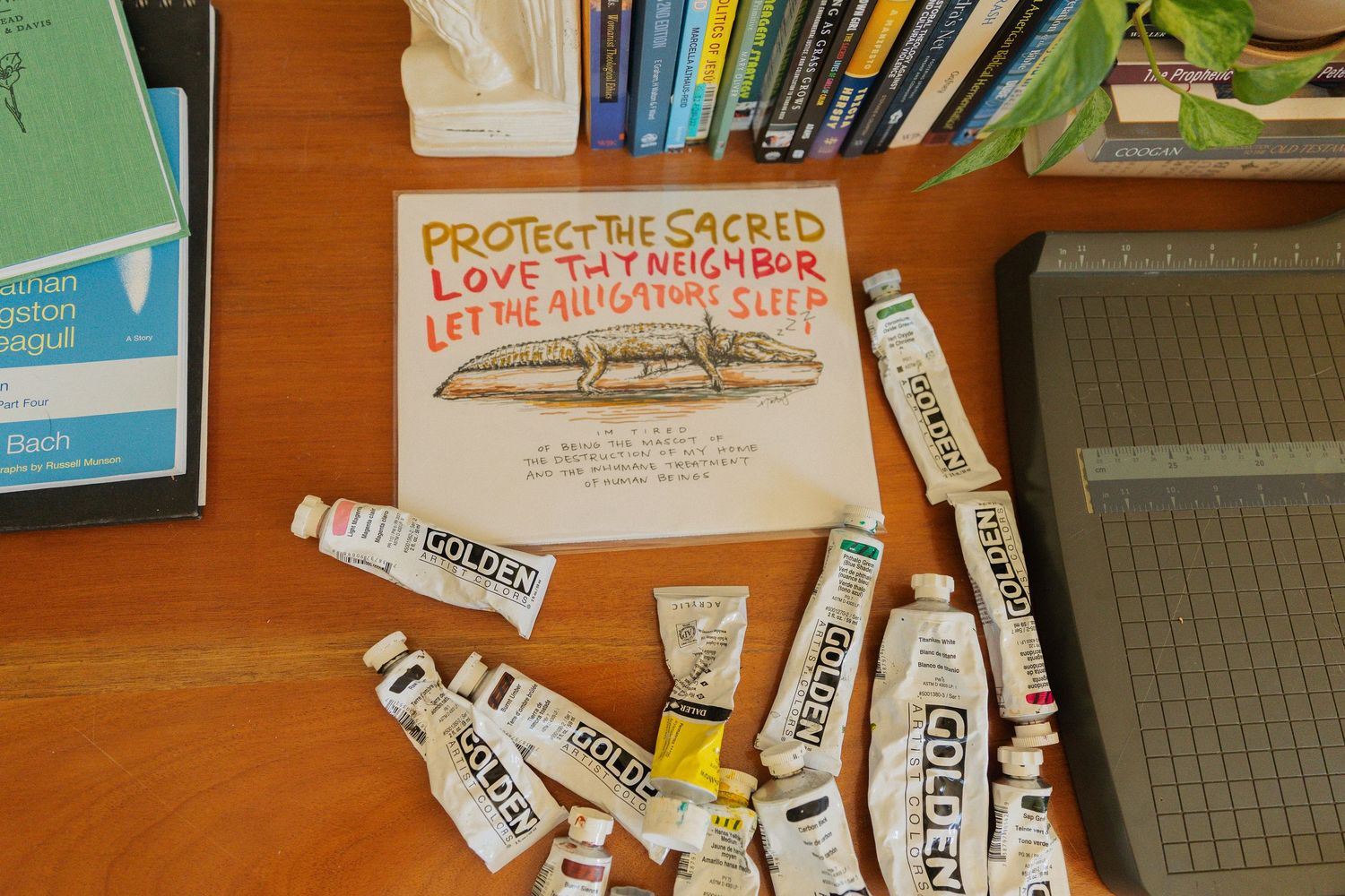 A collection of books and papers stacked on wooden shelves with handwritten labels visible.