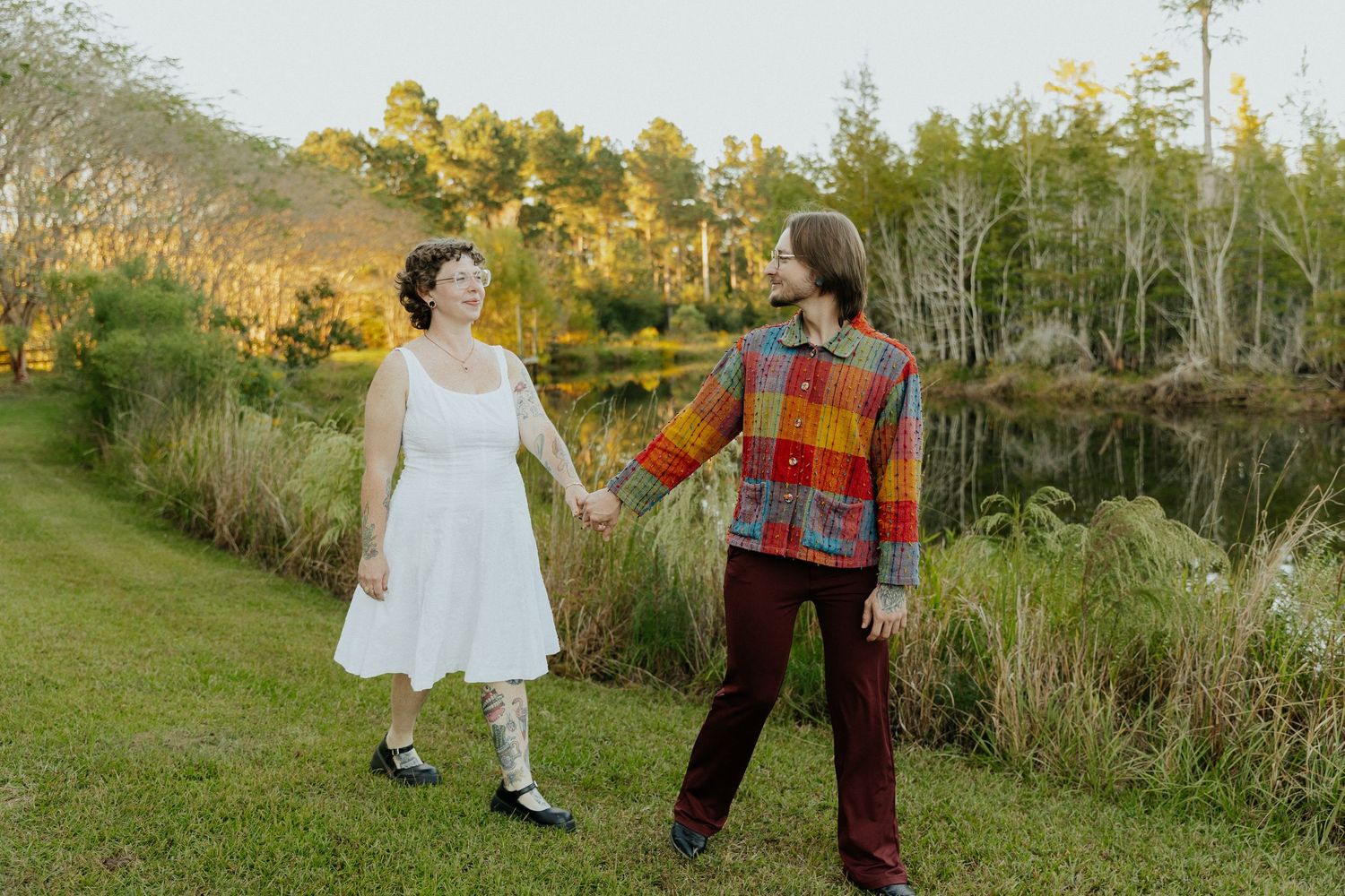 People enjoying a playful moment together in a sunlit autumn field.