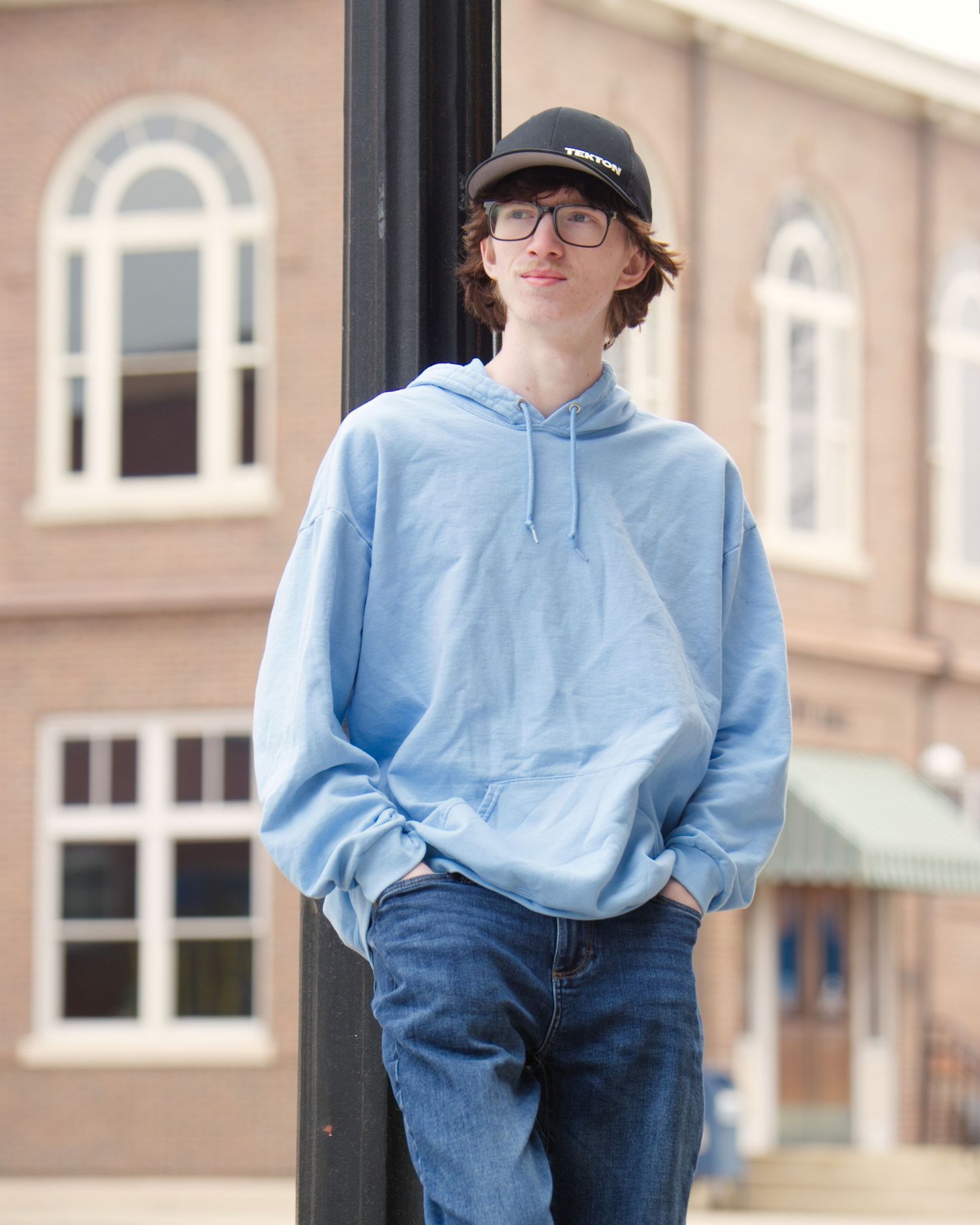 boy in front of light post