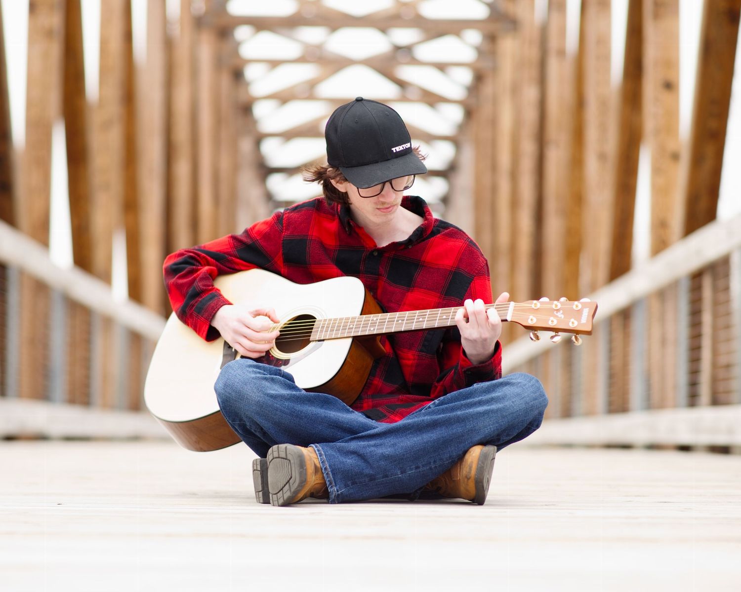 boy sitting playing guitar
