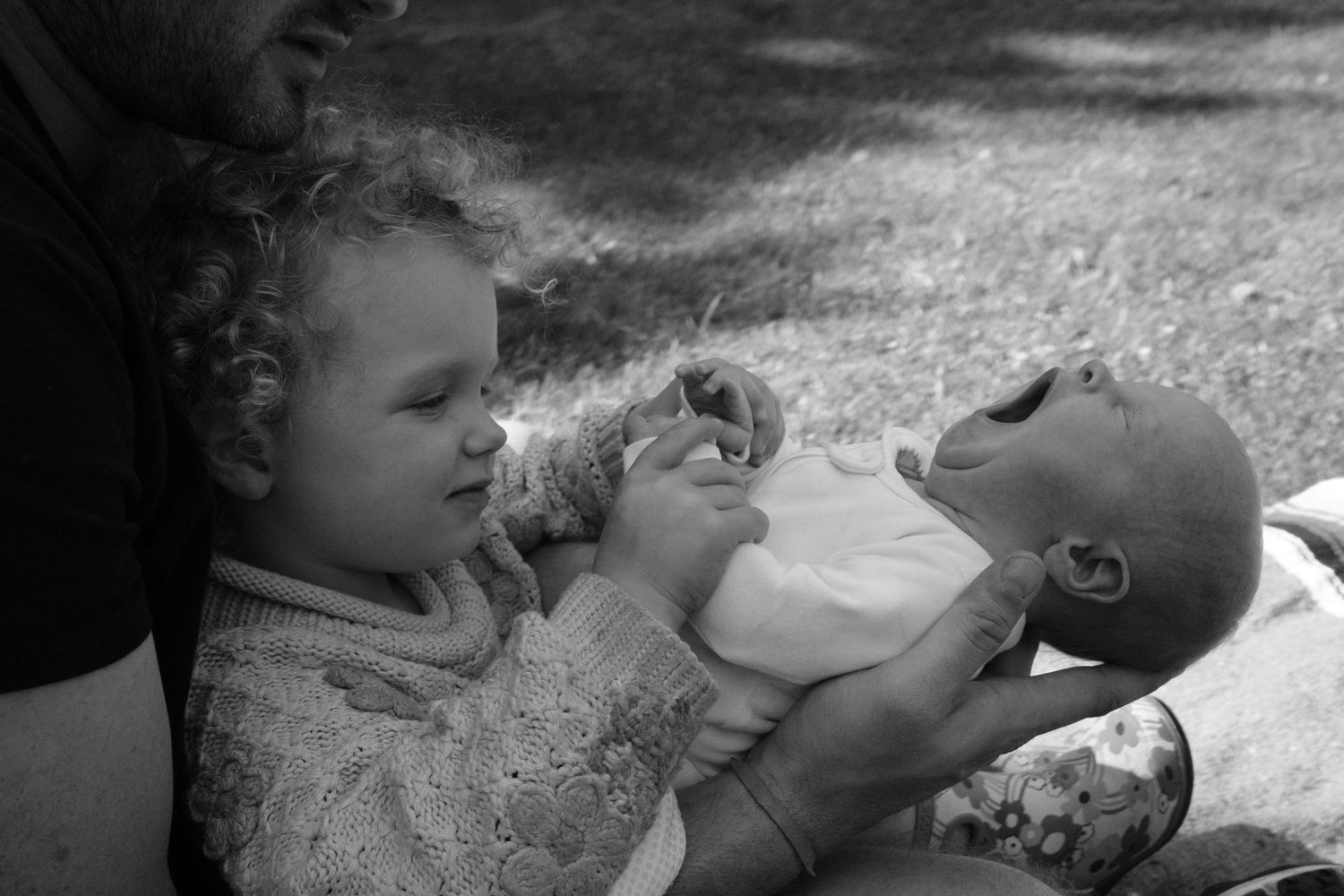 Black and white photos of a baby eating and playing.