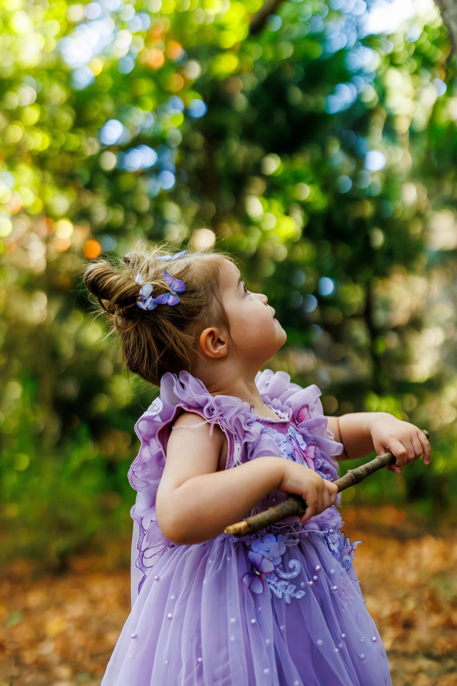 A whimsical scene of purple tulle dresses twirling in a sunlit forest setting.