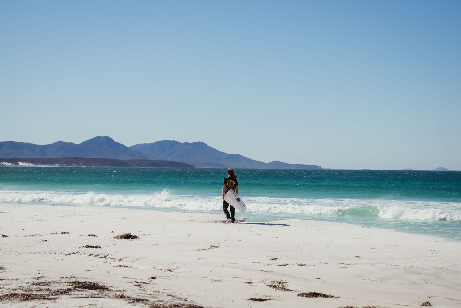 Man standing by rugged coast line