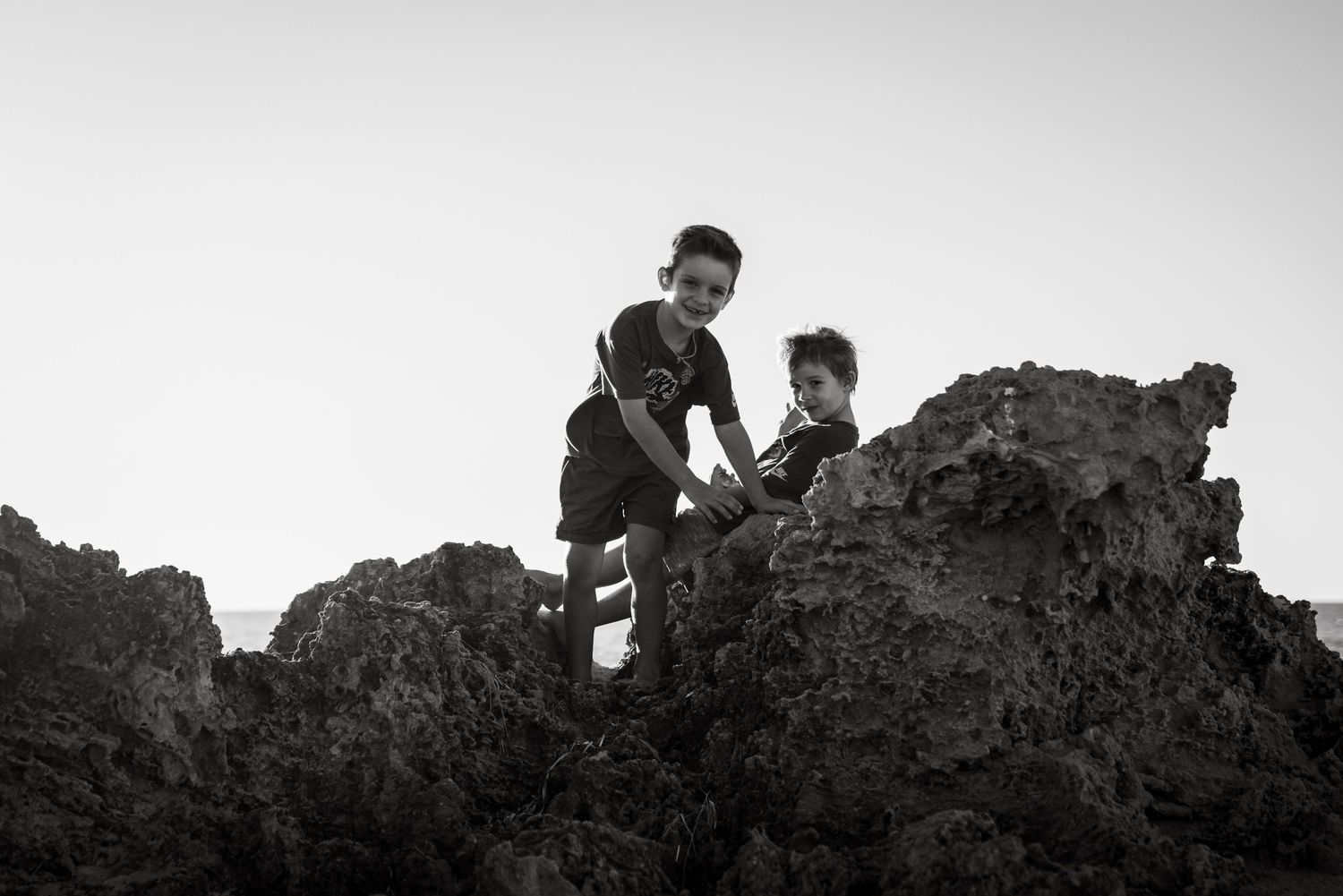 Two boys playing on rocks