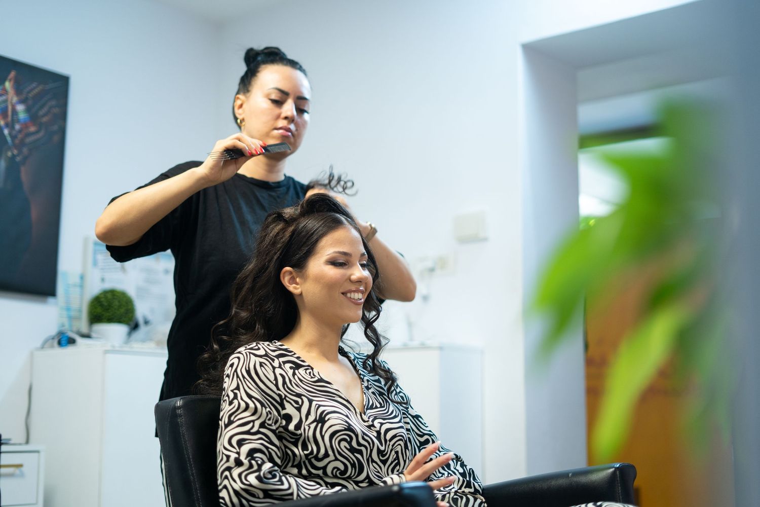 A styling session in progress at a modern beauty salon with minimalist decor.