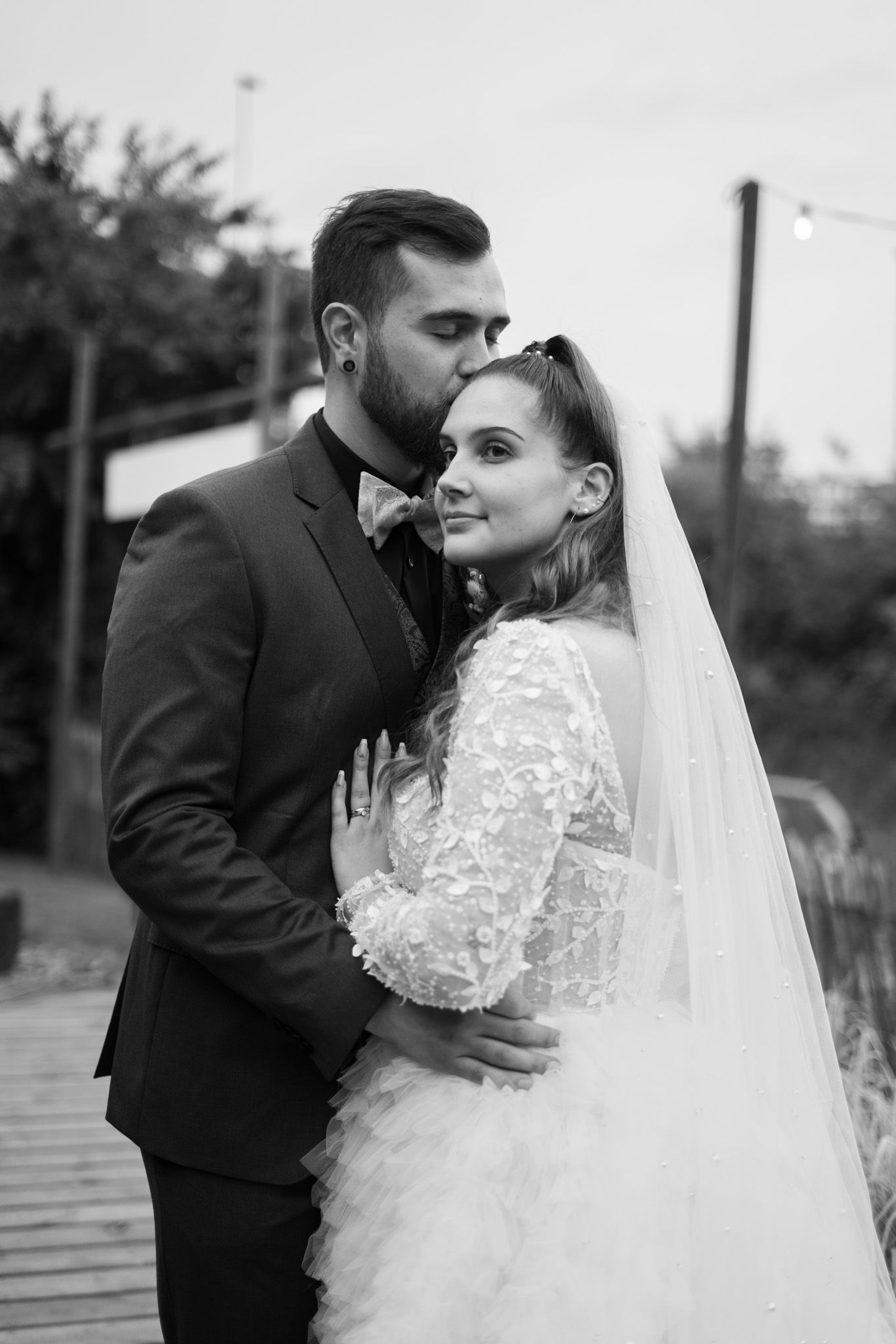 Black and white wedding portraits capturing intimate moments between newlyweds.