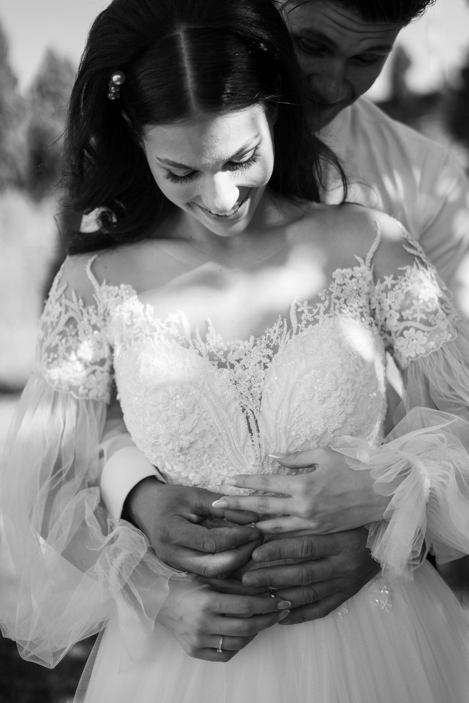 Close-up details of an elegant lace wedding dress with intricate embellishments.