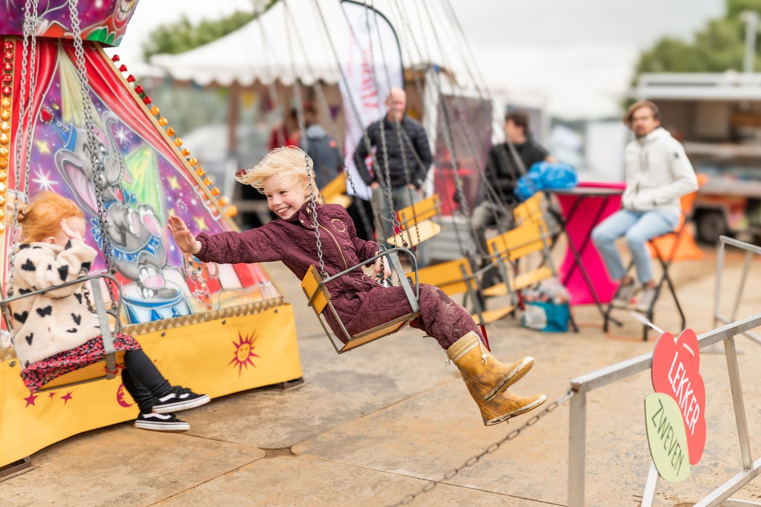 Colorful carnival rides and amusement park attractions set up at an outdoor fair or festival.