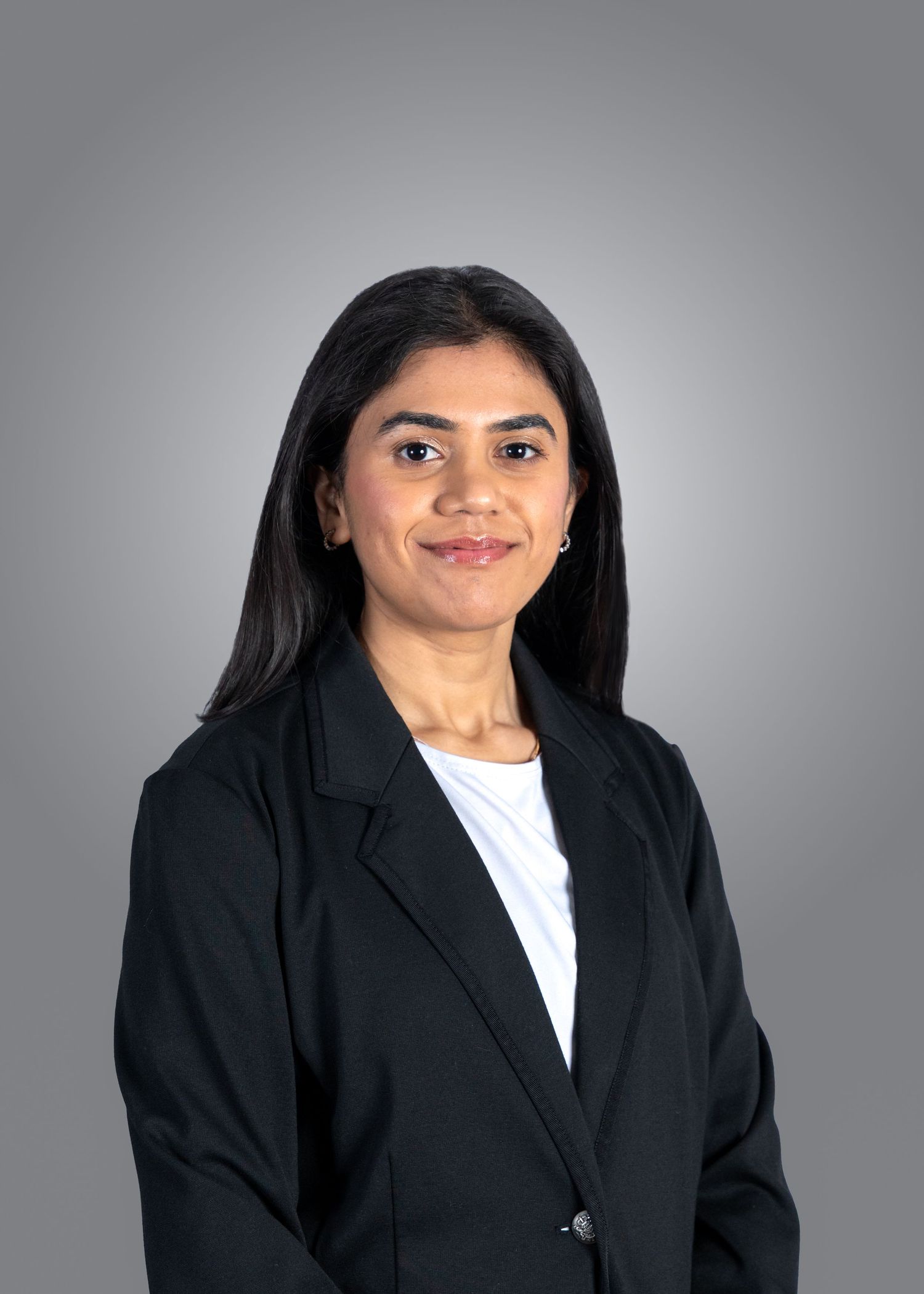 Portrait series showing different poses of a person wearing a black suit against a grey backdrop.