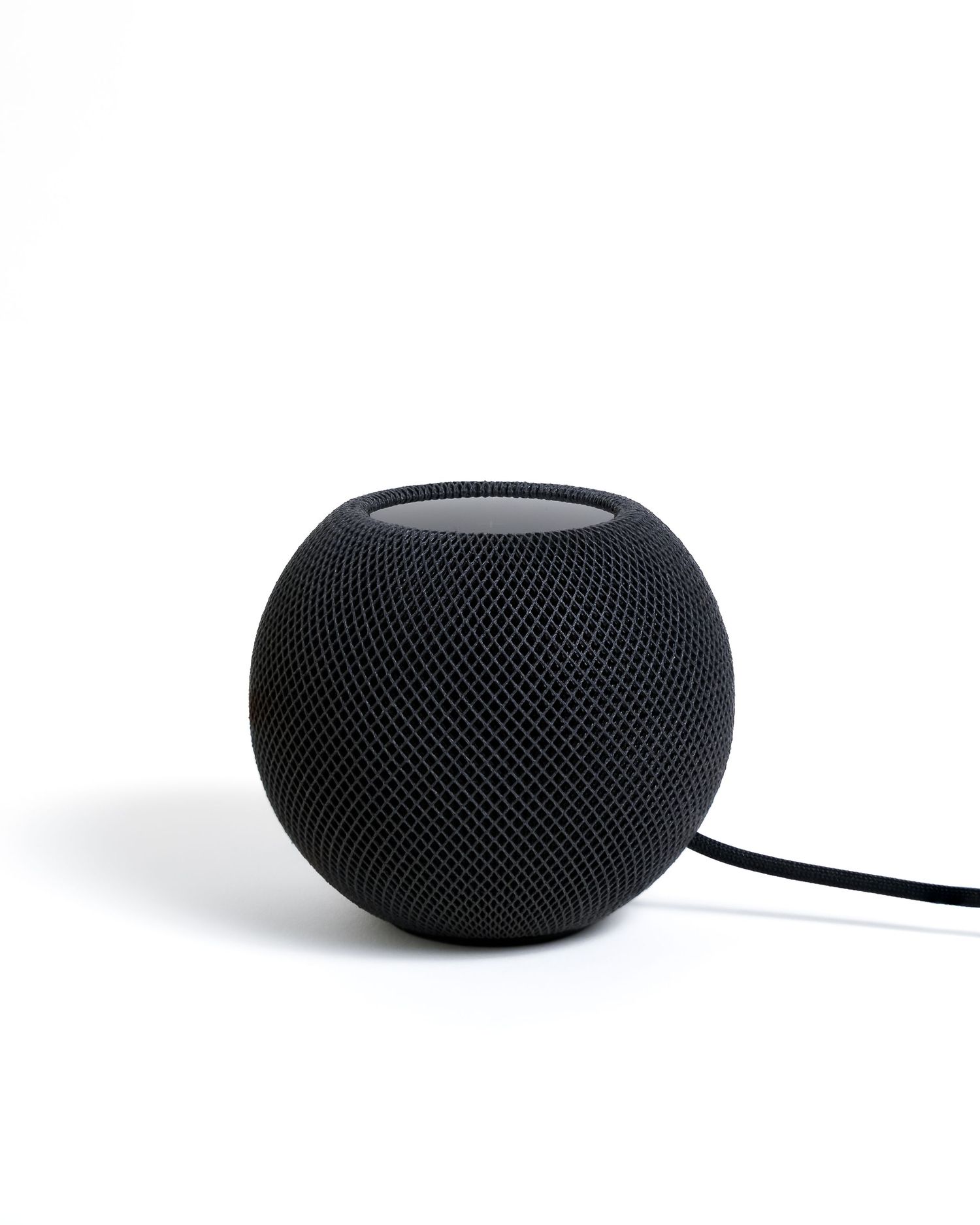 Black Apple HomePod Mini smart speaker shown from different angles on white background.