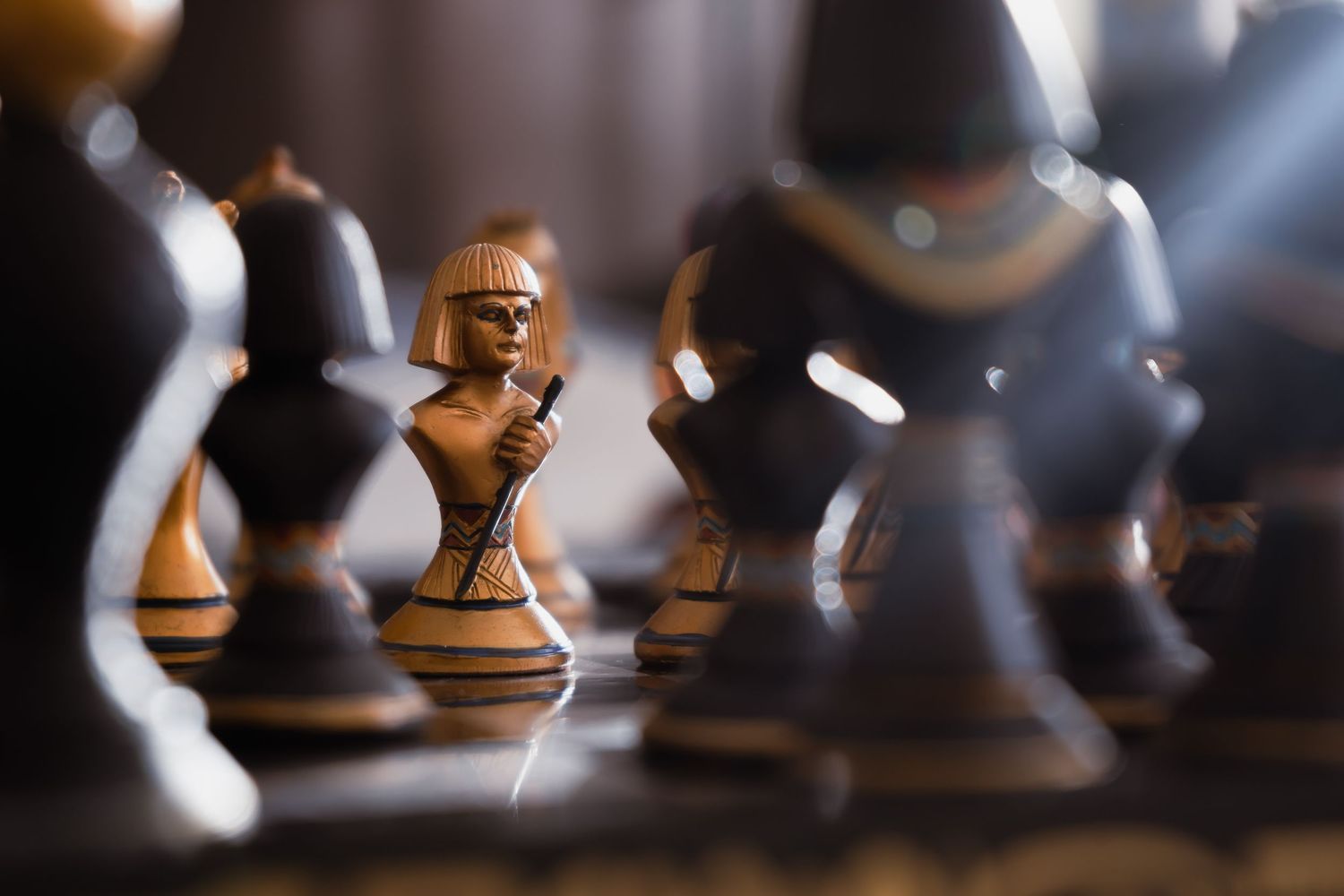 Close-up view of chess pieces in dramatic lighting showing strategic game positioning.