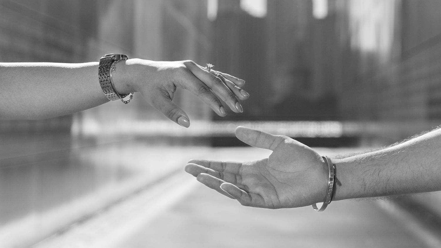 Close-up of hands creating abstract shadows and patterns in bright light.