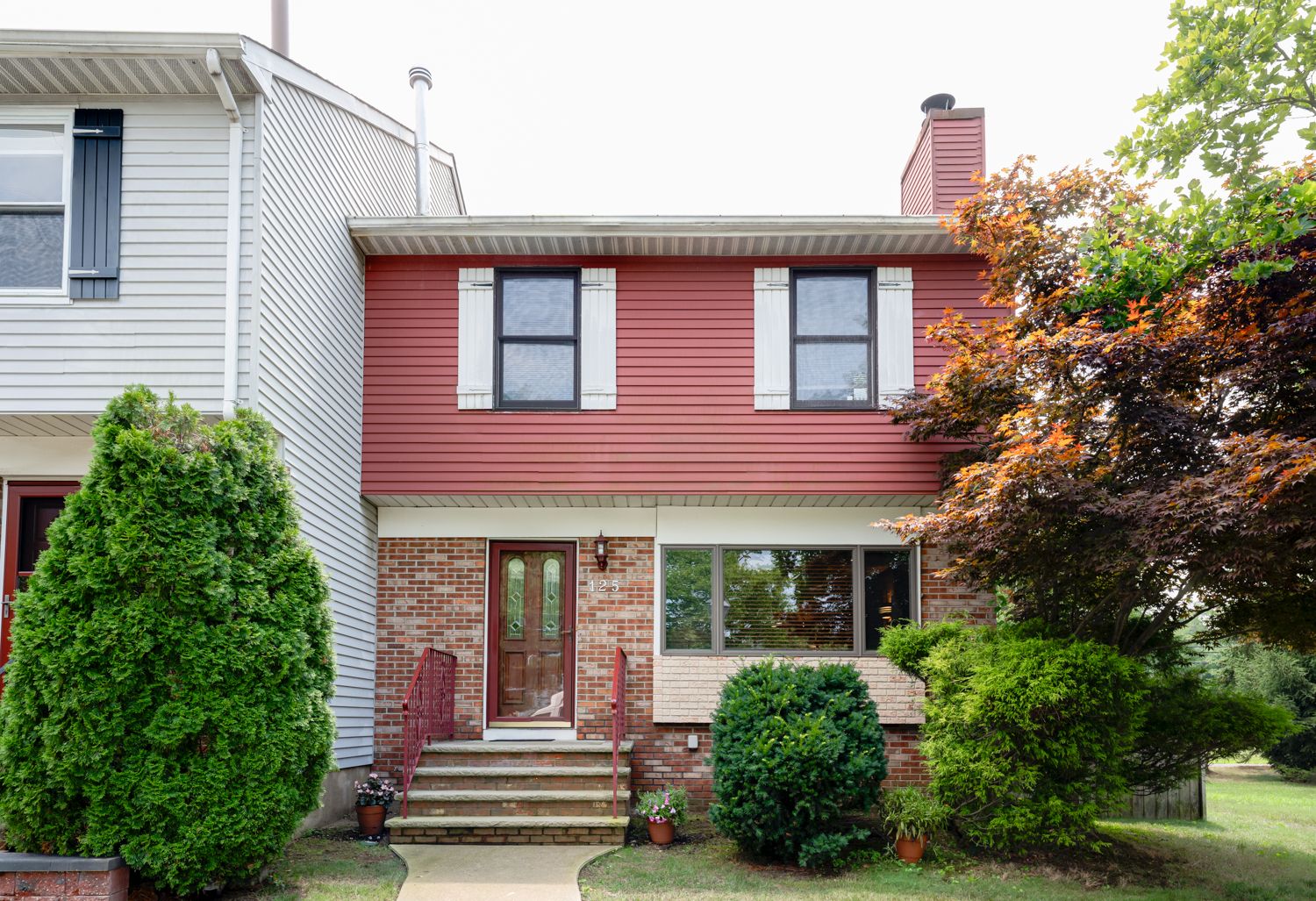 A suburban home renovation sequence showing an aging red brick exterior being progressively updated and modernized.