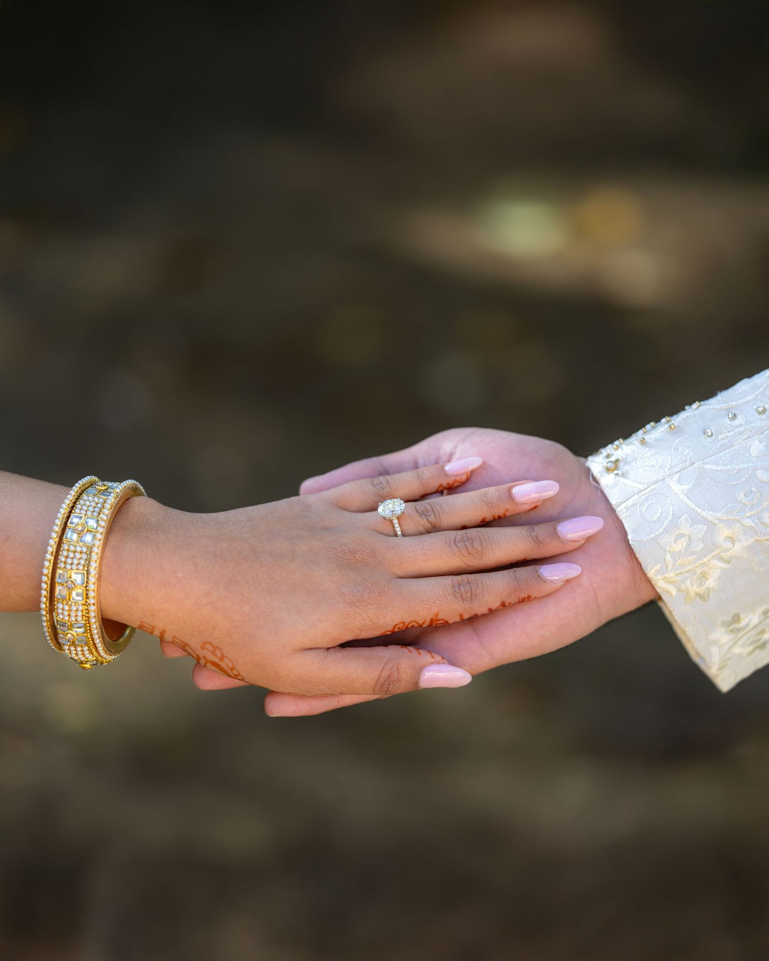Series of hands reaching towards each other wearing traditional wedding jewelry.