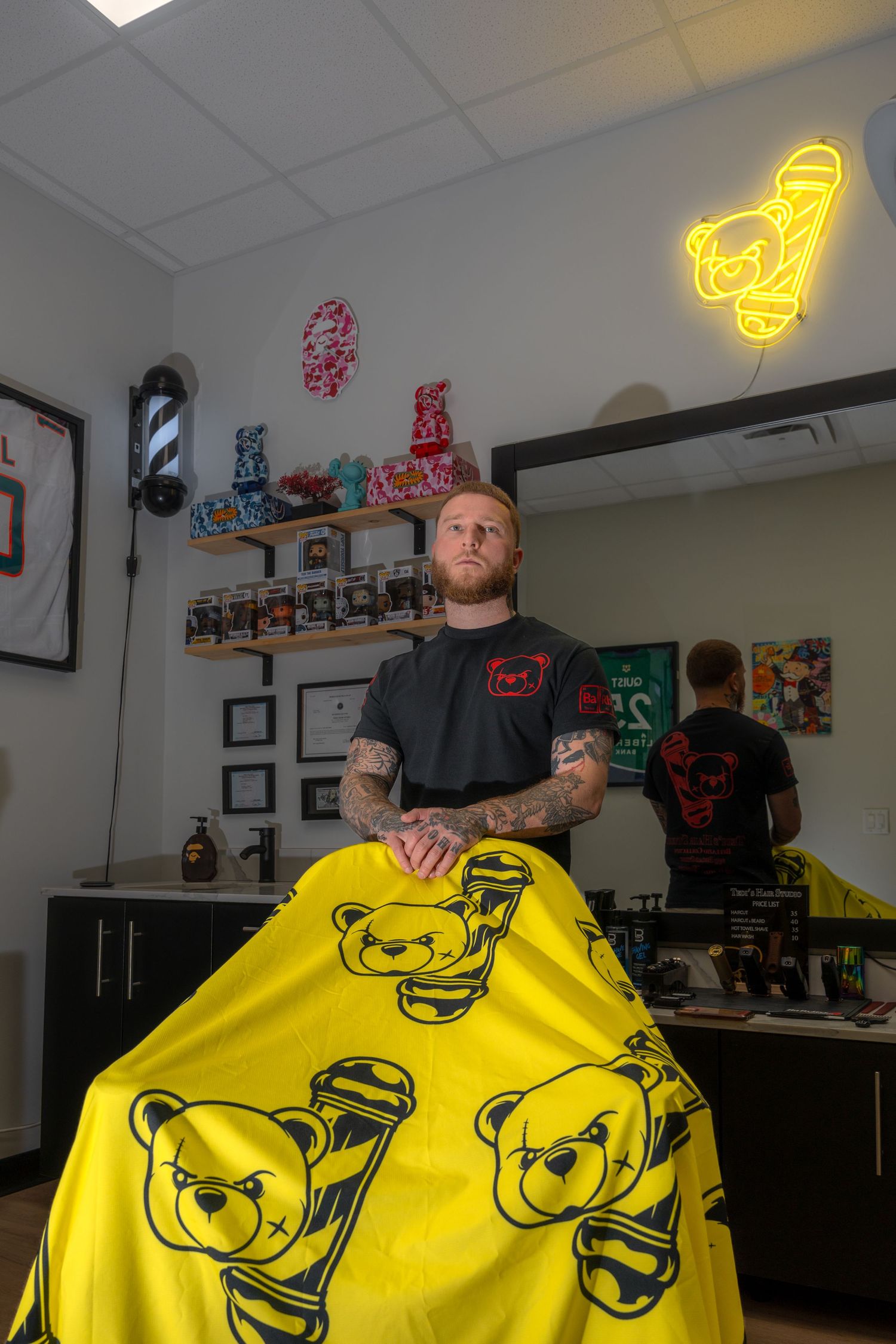 Yellow teddy bear pattern t-shirt design being displayed in a retail shop setting.