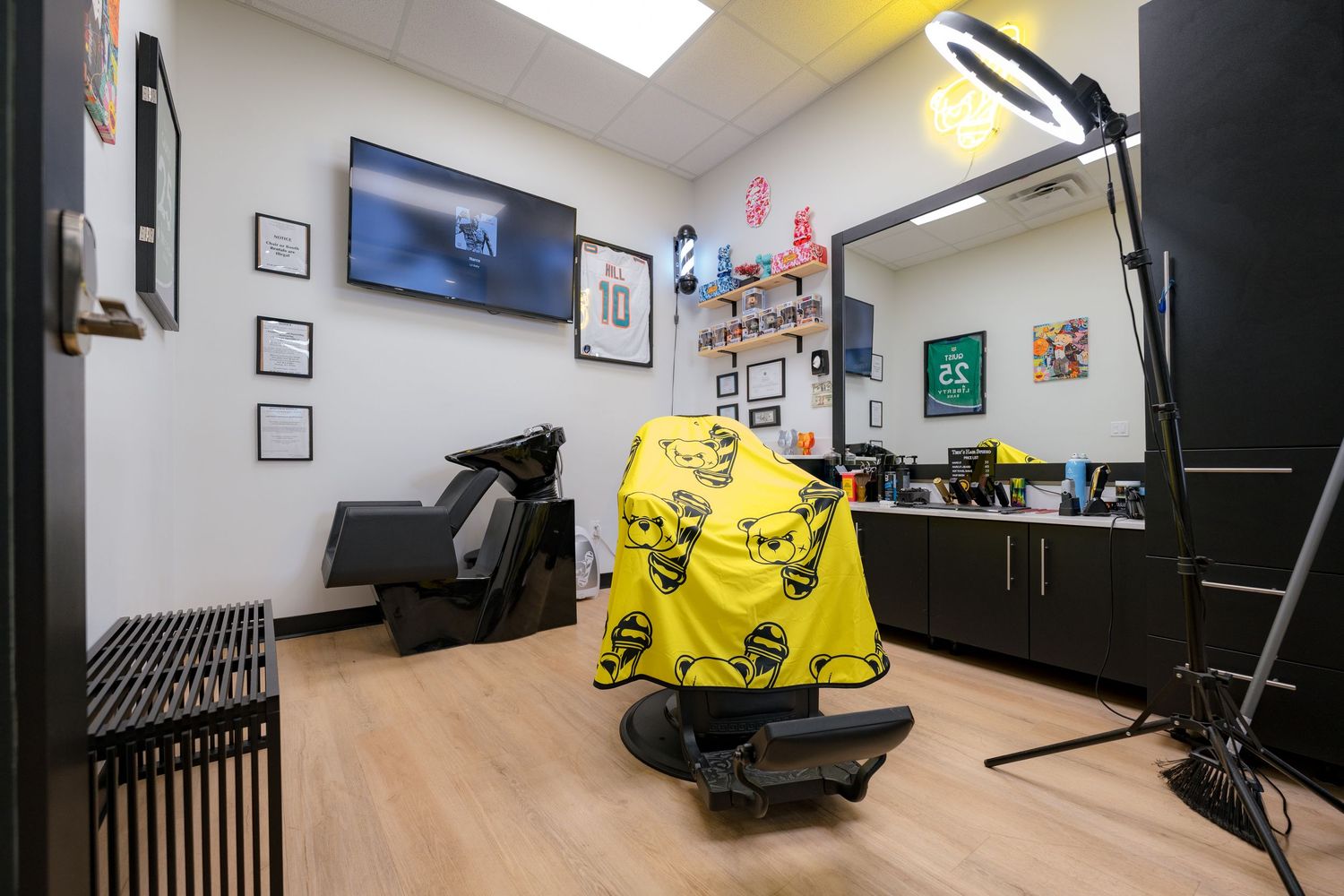 Interior view of a modern fitness gym with workout equipment and black padded flooring.