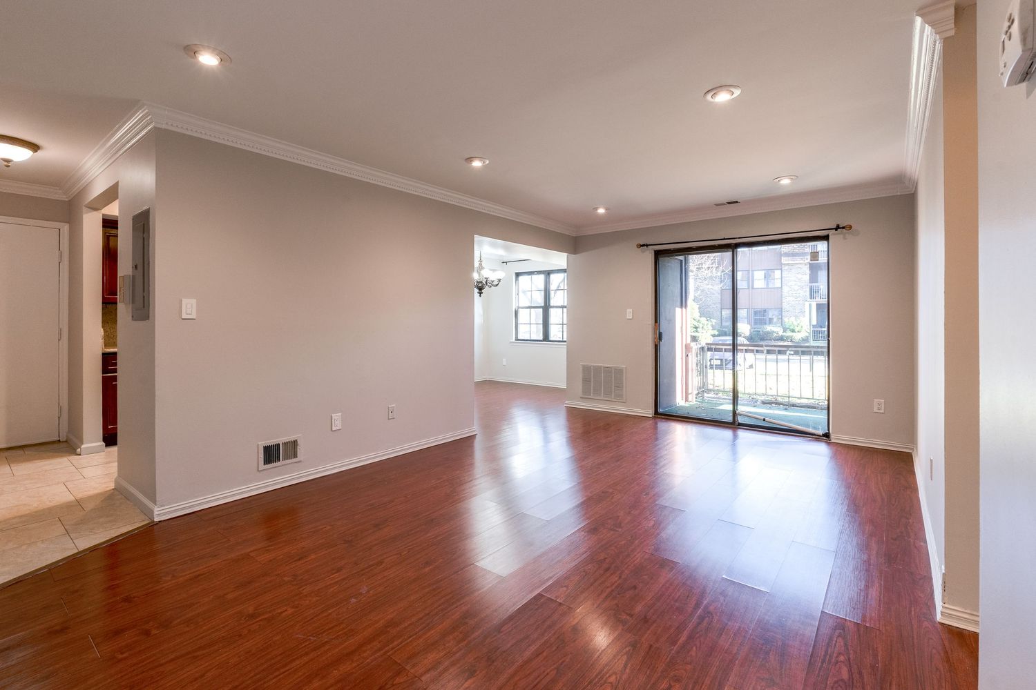 Modern townhouse interior features gleaming hardwood floors, recessed lighting and an open concept layout in warm neutral tones.