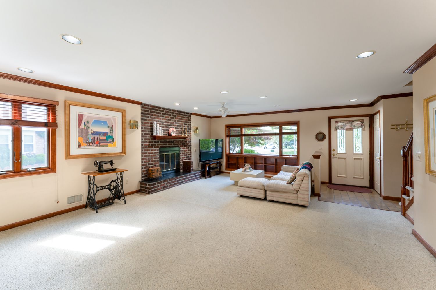 Seamless panoramic collage showing the bright and spacious interior of a modern home with hardwood floors and white walls.