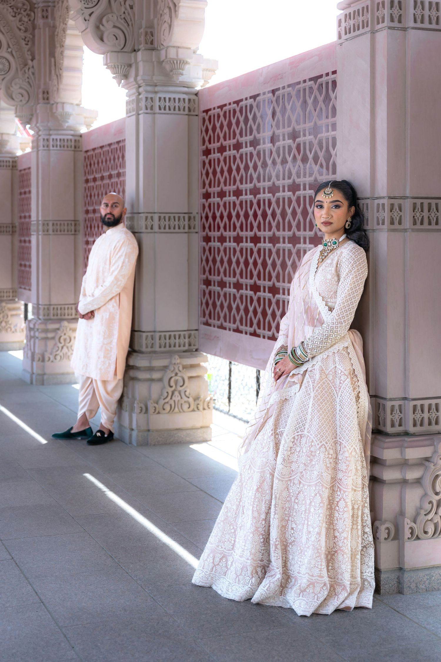 Series showing someone in a white lace dress posing along an ornate architectural colonnade.