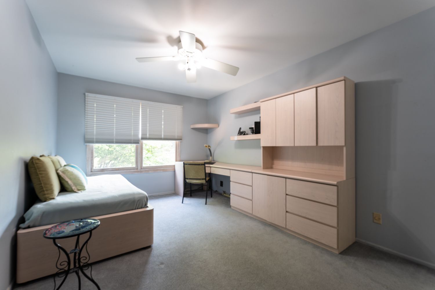 A minimalist bedroom with built-in storage solutions showcases clean lines and neutral tones throughout the space.