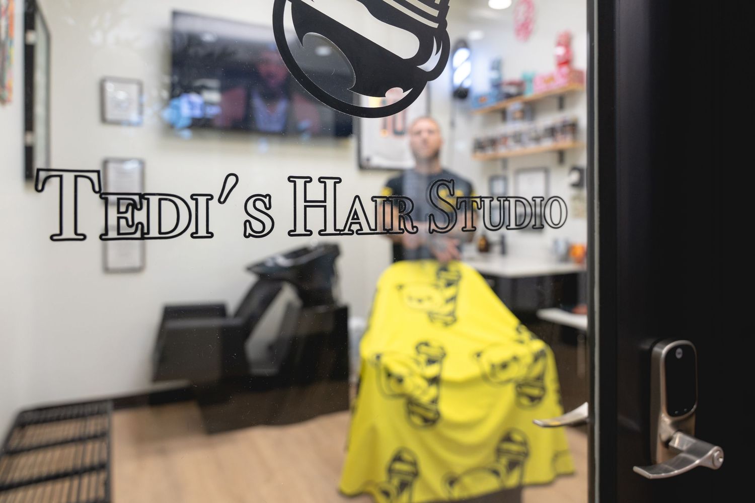 Teddy's Hair Studio storefront sign and window display in shopping center.
