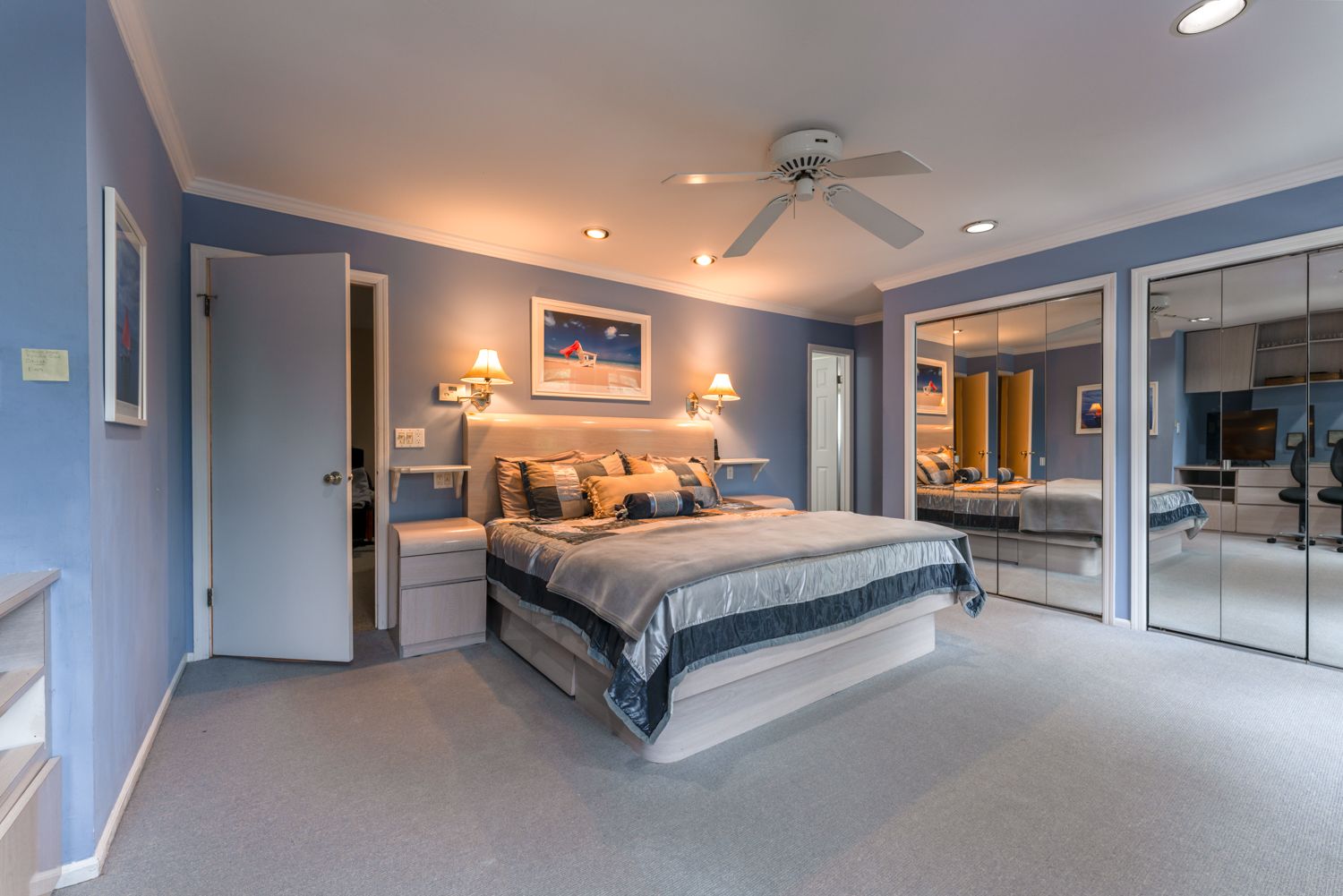 Modern minimalist apartment interior features sleek grey walls and ceiling fan in an open plan living space.