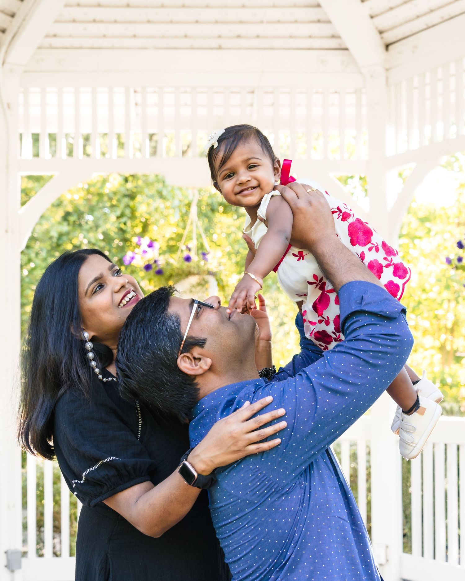 A family moment captured in a series of joyful interactions under a white gazebo.