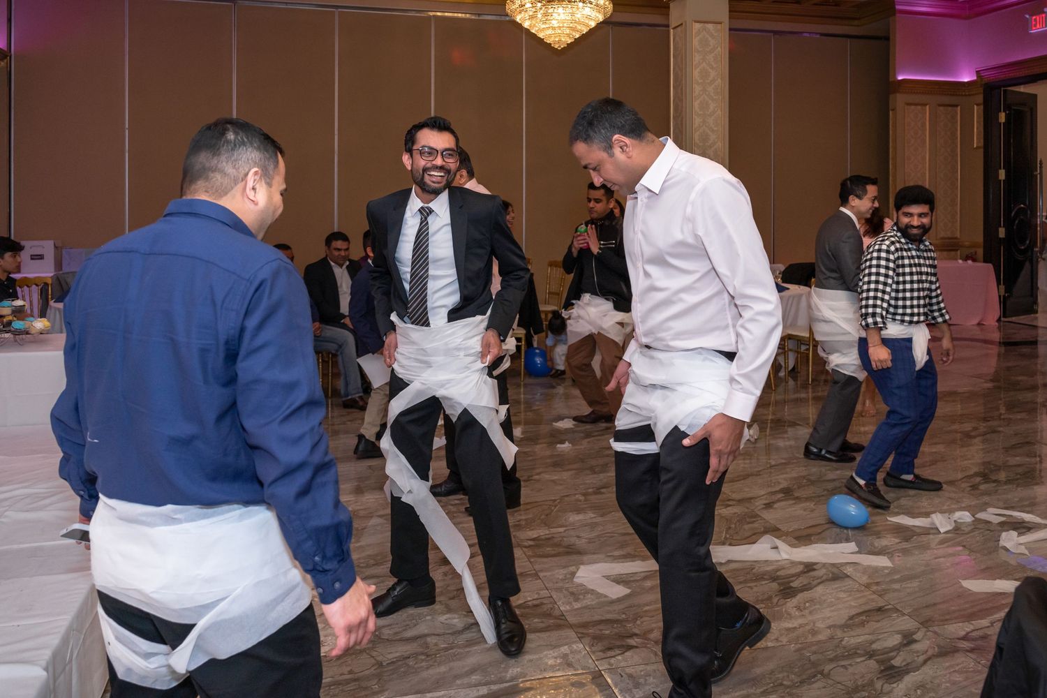 Guests dancing in a banquet hall during a lively celebration.