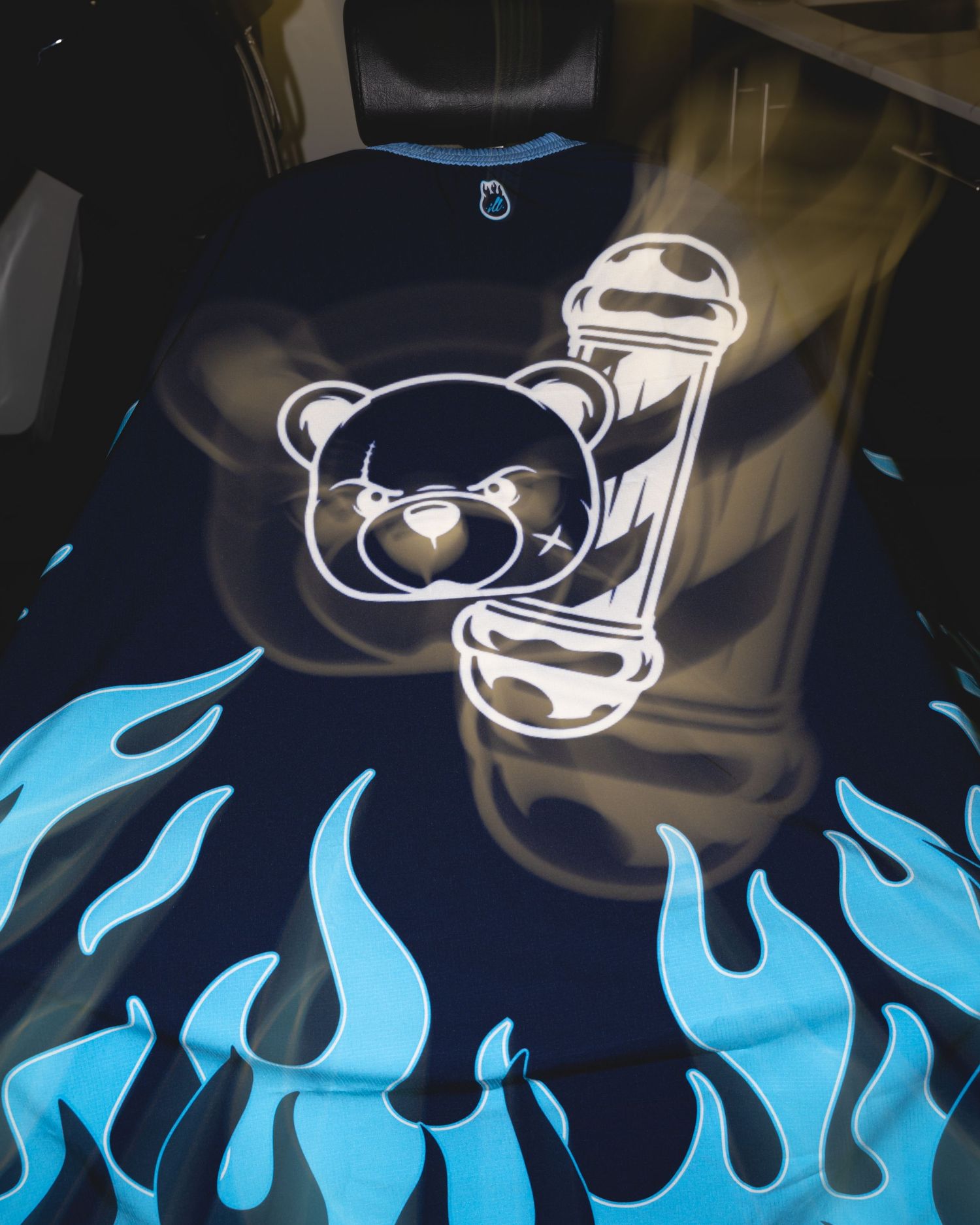 Dark t-shirt featuring cartoon bear heads with blue flames design pattern.