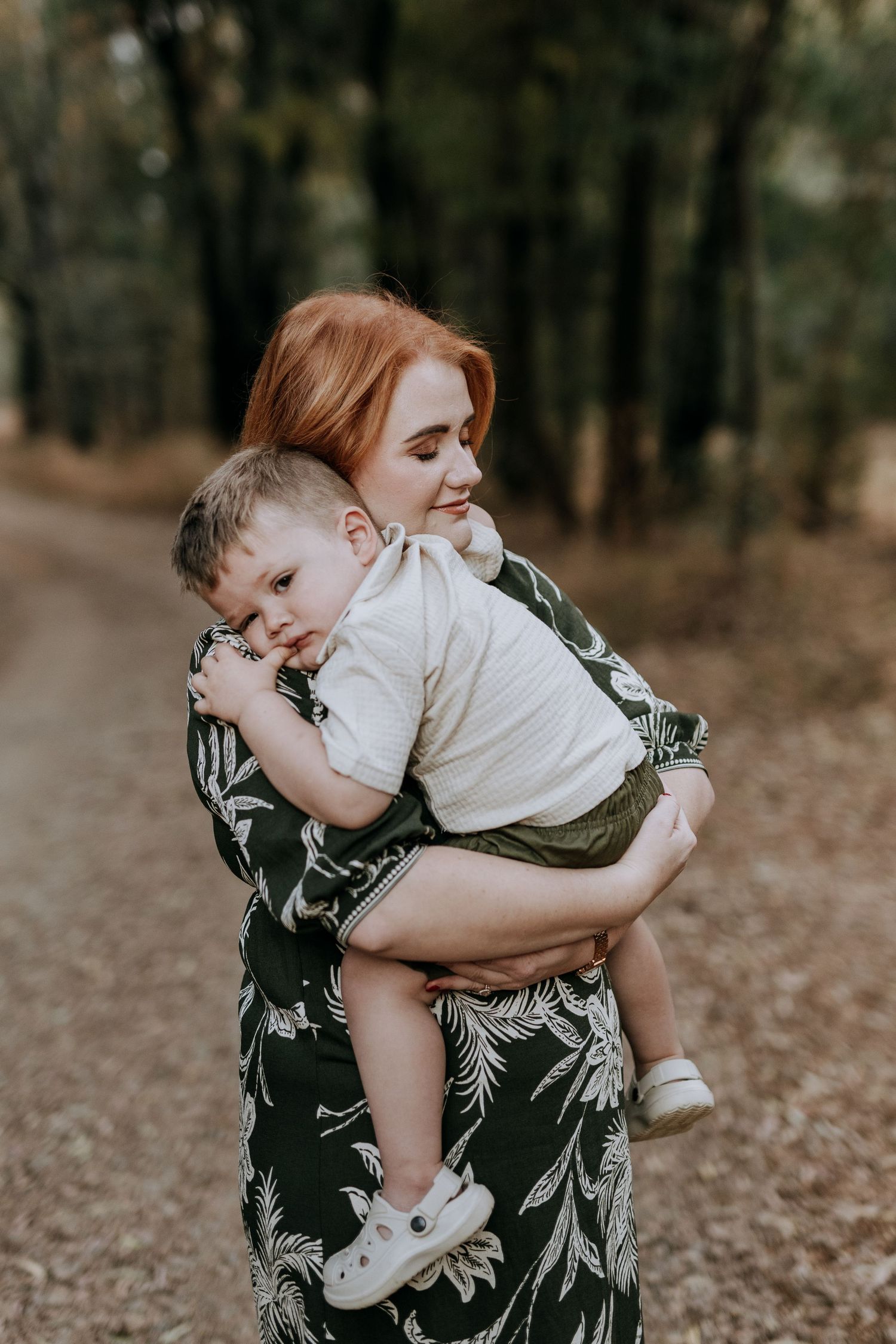 A sweet embrace between mother and child outdoors in autumn as they share a playful bonding moment together.