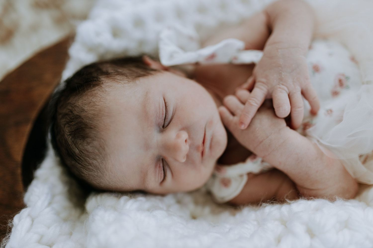 A collage of newborn baby photography with soft white textiles and gentle natural lighting.