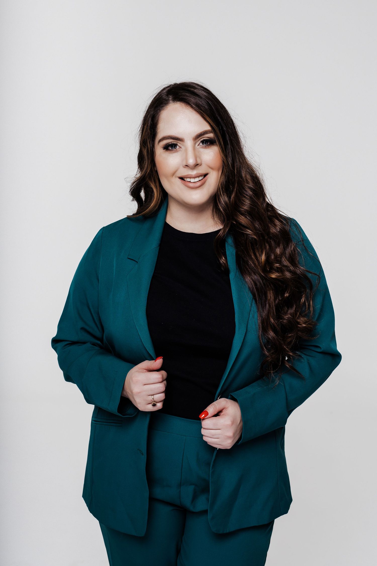 Professional in a teal blazer and black top poses against a light gray studio backdrop in a four-part photo series.