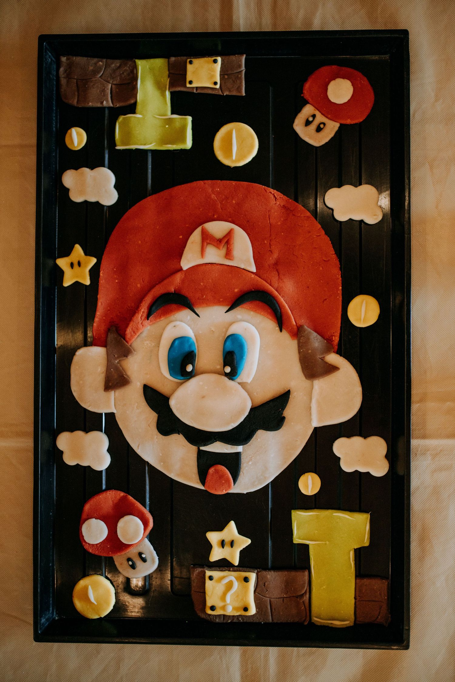 Wall art display featuring Mario-themed decorative pieces with mushrooms, stars, and character portraits in warm vintage tones.