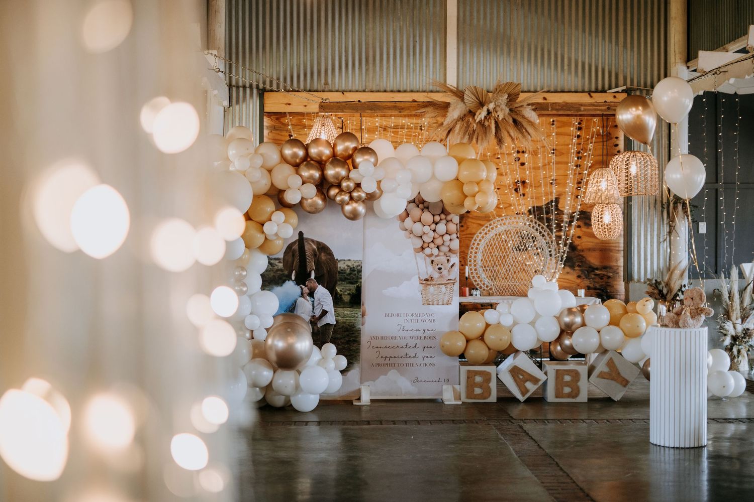 Elegant wedding venue decorated with white balloons, string lights, and floral arrangements creating a romantic ambiance.