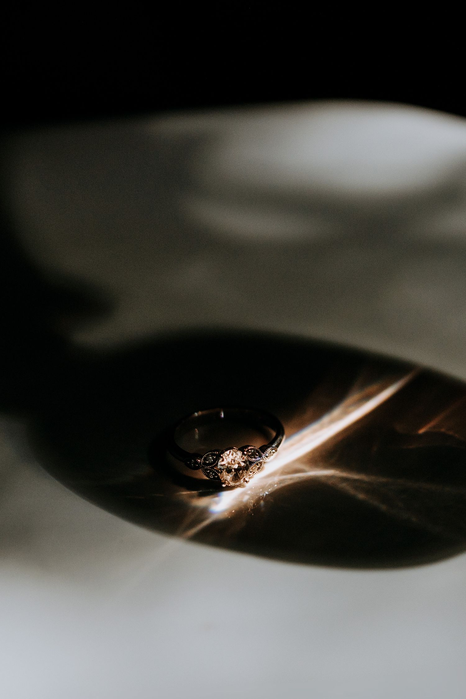 Abstract macro photography sequence showing light reflections and shadows on a dark metallic surface.