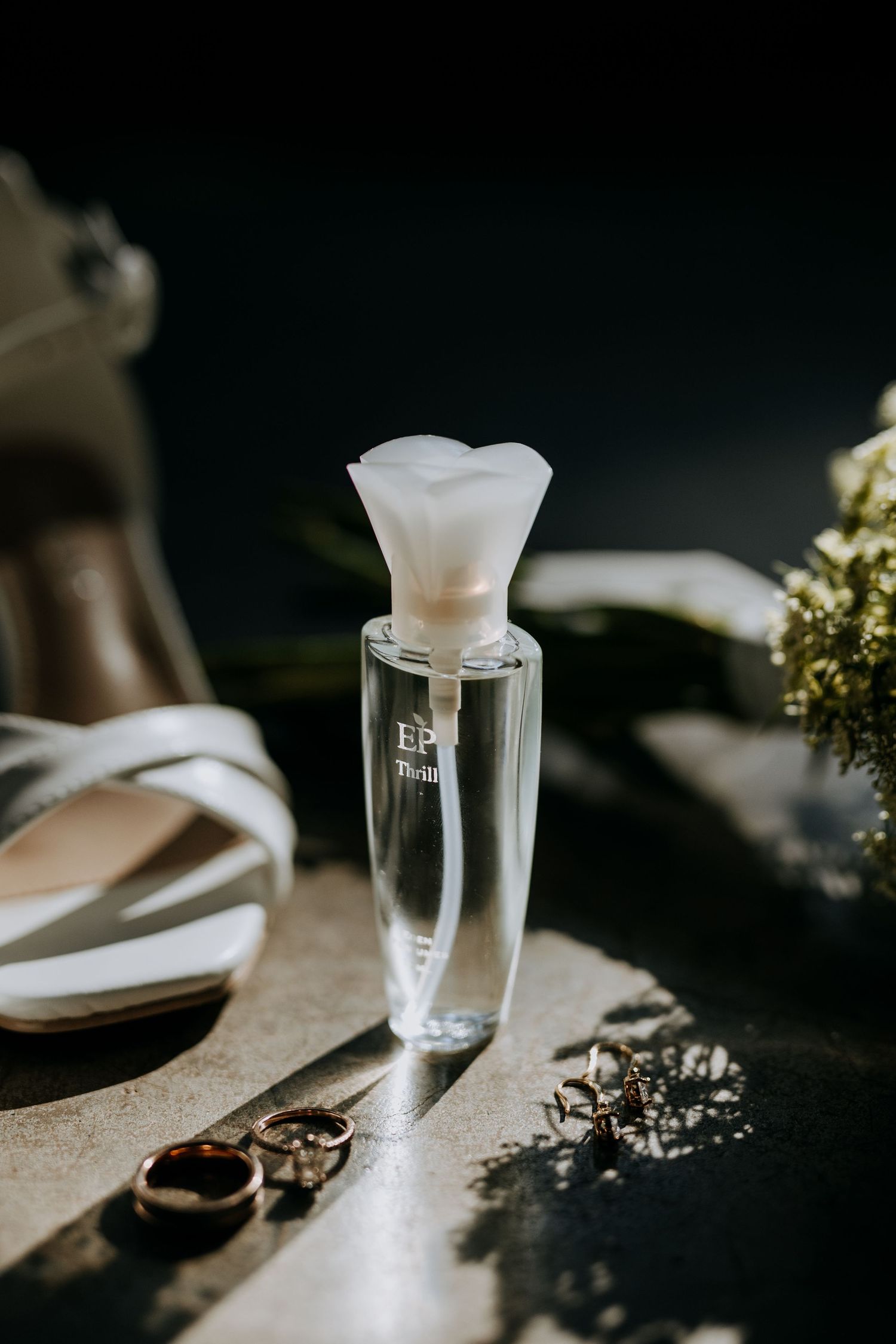 Elegant champagne glasses with frosted details sit on dark surfaces in dramatic lighting, creating a romantic ambiance.