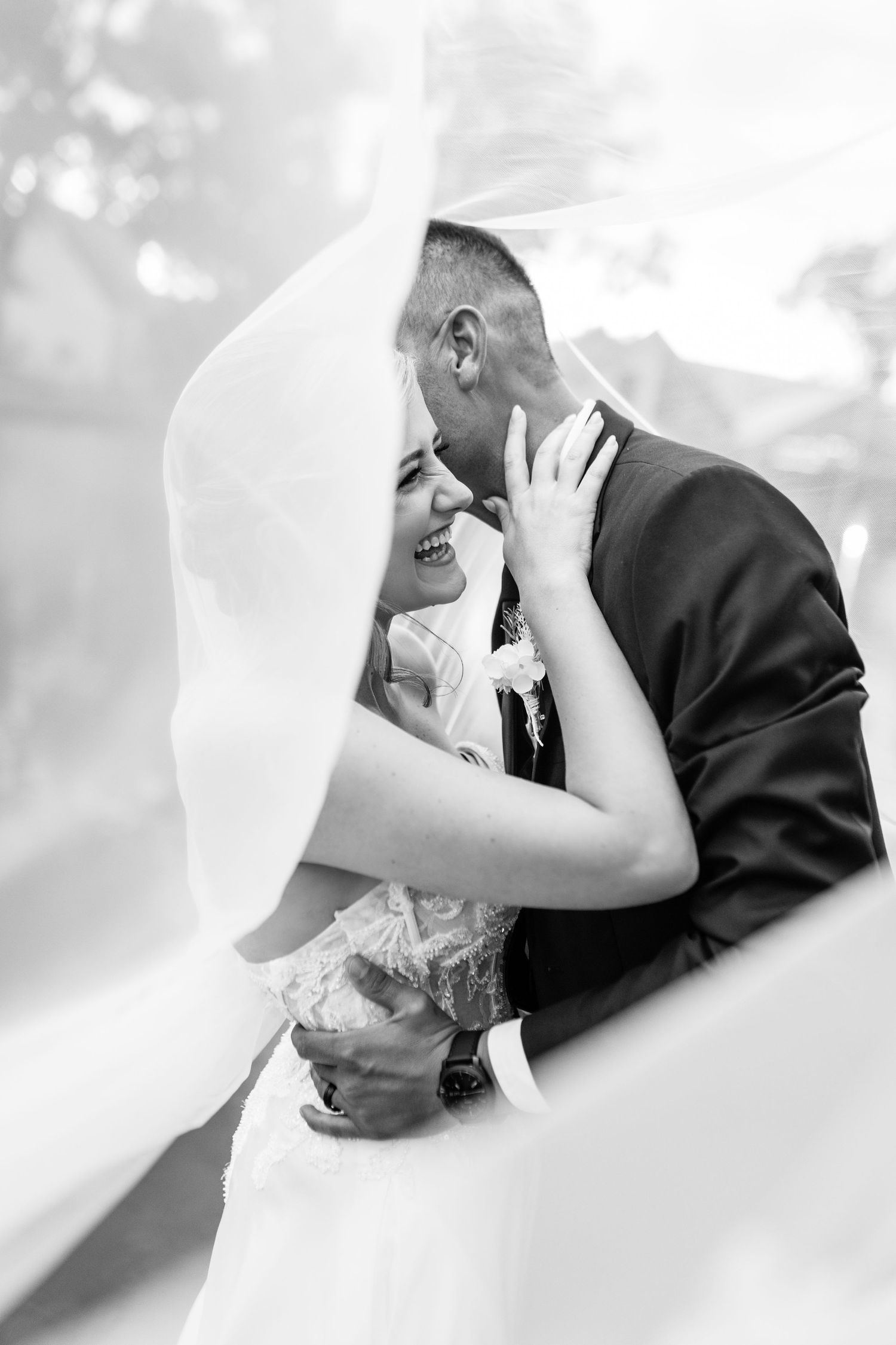 A romantic black and white wedding photo series showing three intimate dips between a bride and groom.