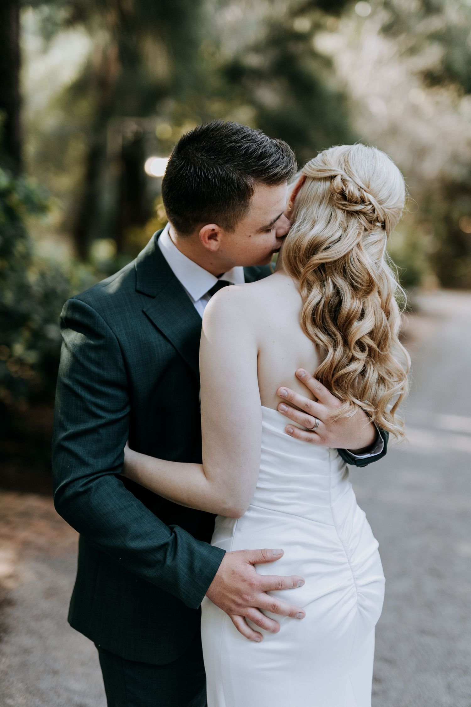 A romantic wedding sequence showing tender moments between newlyweds in the woods.