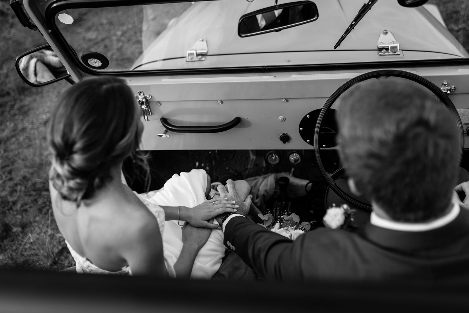 Seven black and white film stills show figures in various car-related scenes creating a cinematic sequence.