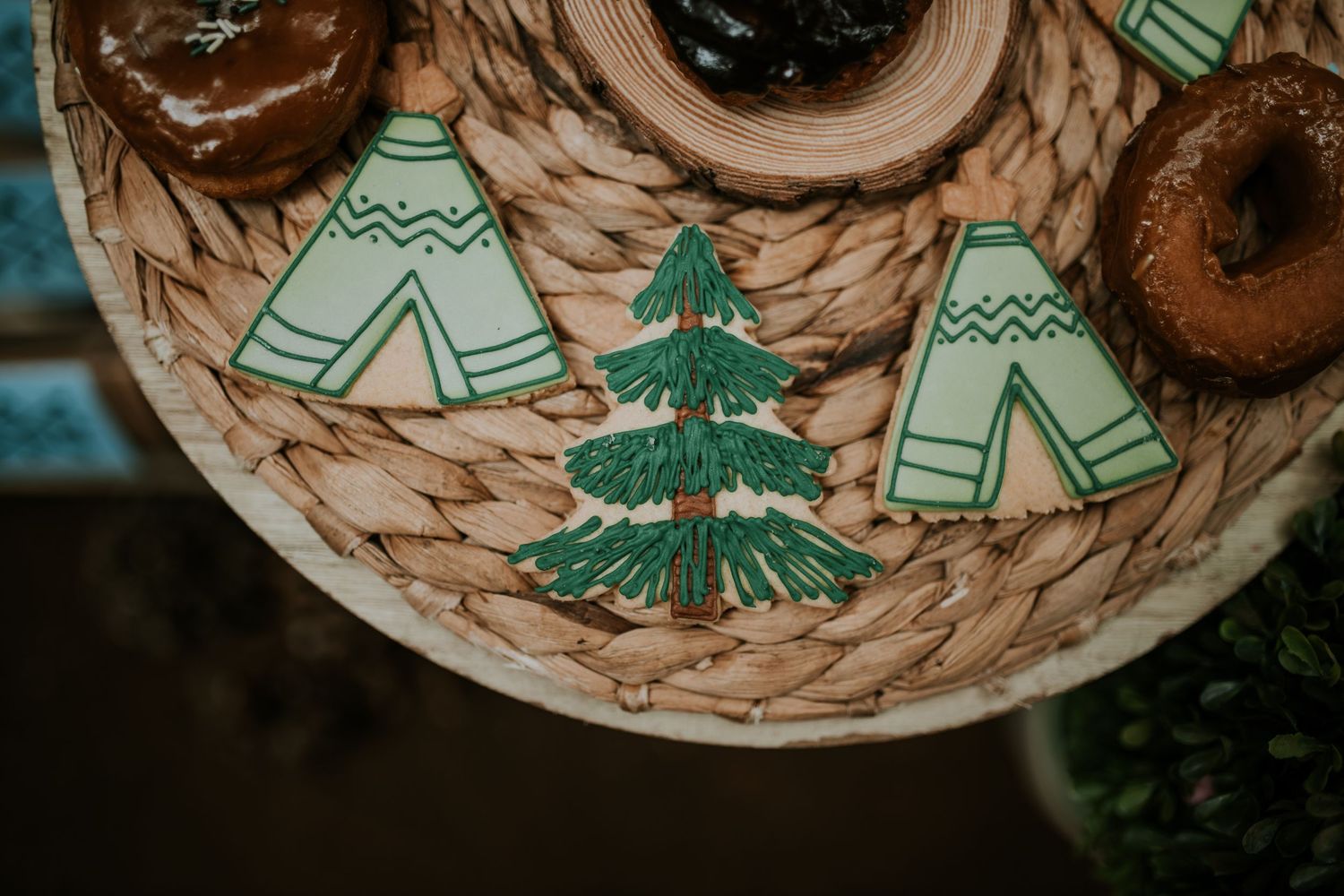 Close-up view of handmade ceramic bowls with painted evergreen tree designs in rustic details.