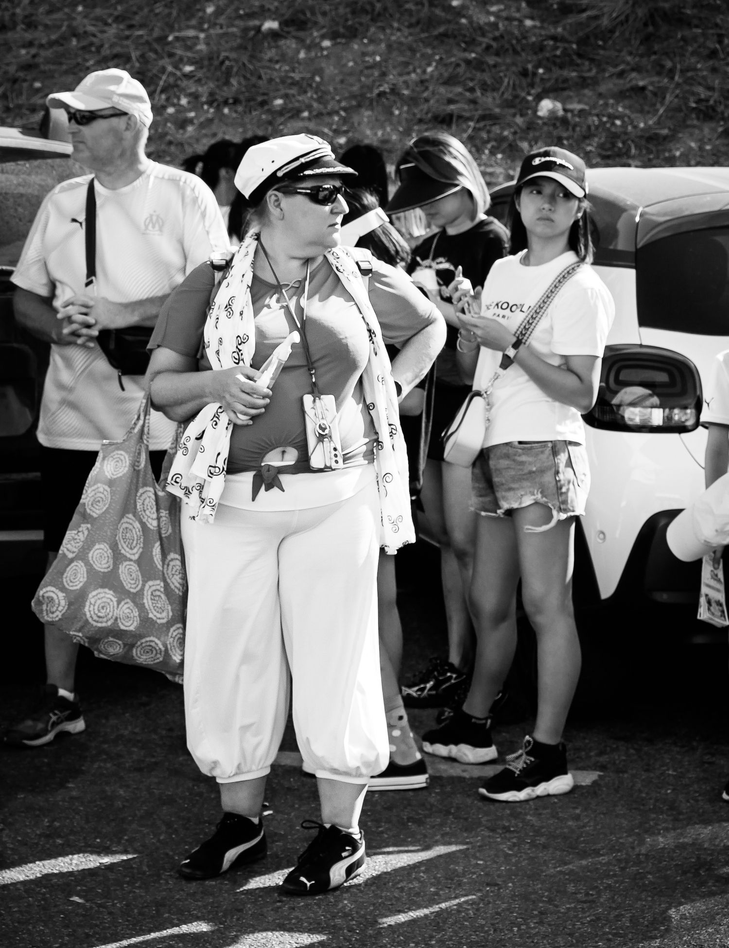 Lady waits for the train at the top of a hill in Marseille.