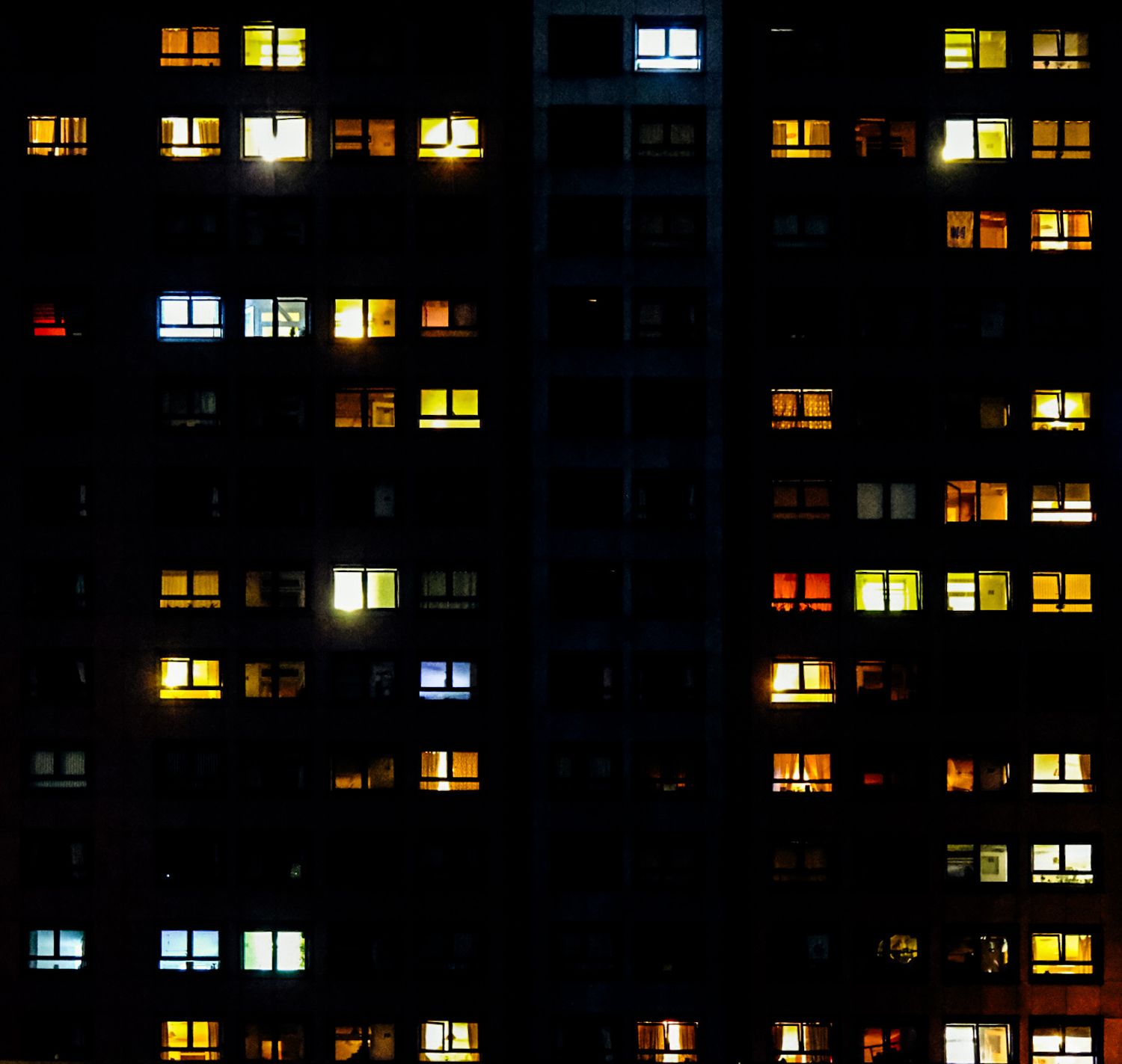 Mottram Towers lit up against a dark sky, windows are visible. Part of the Tellin' Stories project.